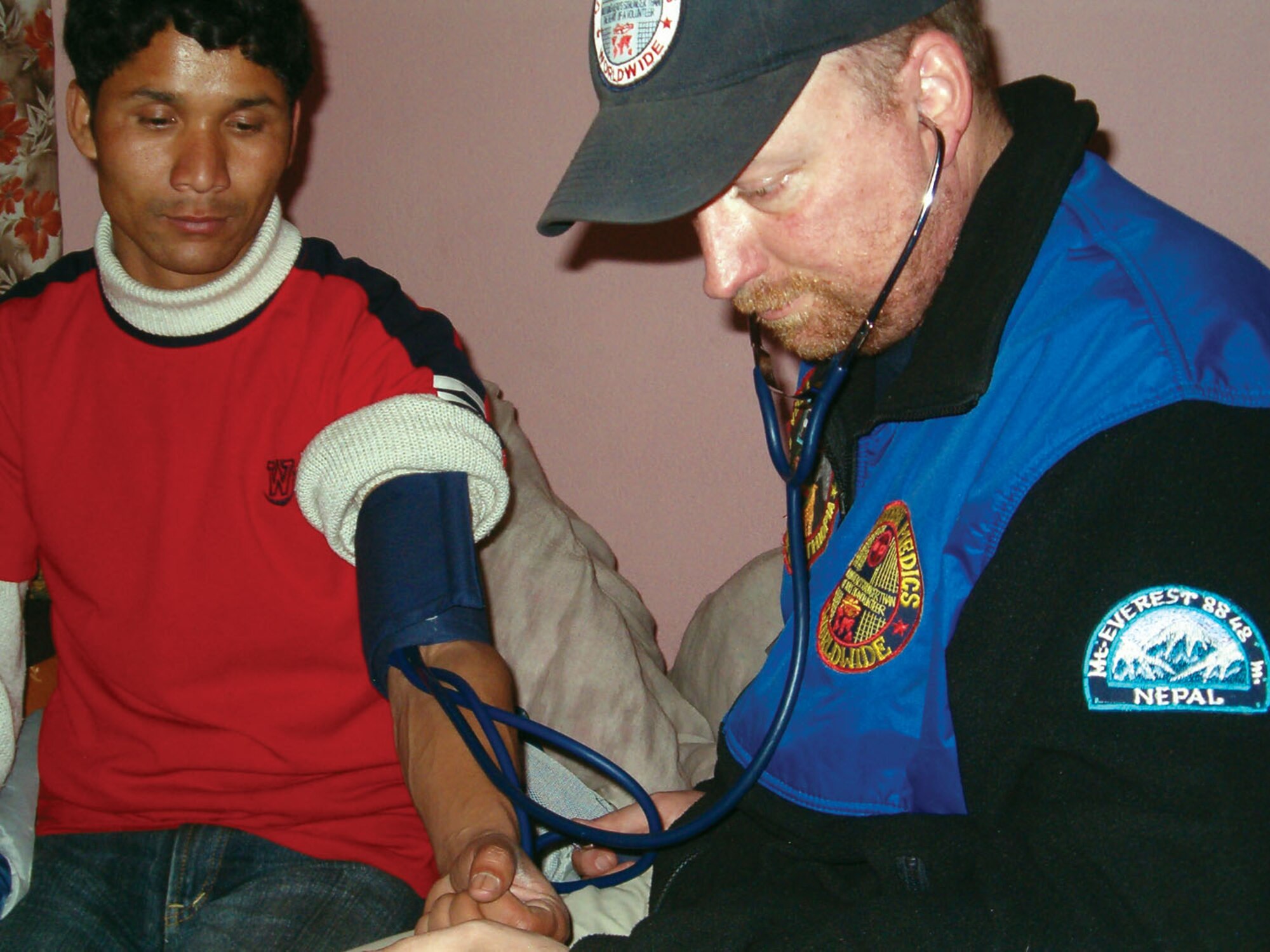 Chris Hamel gives a check up to Mani, director of the orphan children's home in Katmandu, Nepal in March 2008.  When not providing free medical care to citizens of other countries as a member of Volunteer Medics, he is Tech. Sgt. Chris Hamel, a Reservist with 446th Aeromedical Staging Squadron. (Courtesy photo/Gerald Flint)