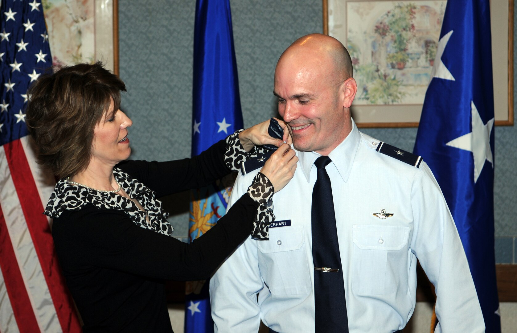 Michelle Everhart, wife of Brig. Gen. Carlton Everhart II, Air Education and Training Command Intelligence and Air, Space and Information Operations for Flying Training deputy director, places new rank on her husbands shoulder boards during his promotion ceremony Jan. 31. (U.S. Air Force photo by Don Lindsey)