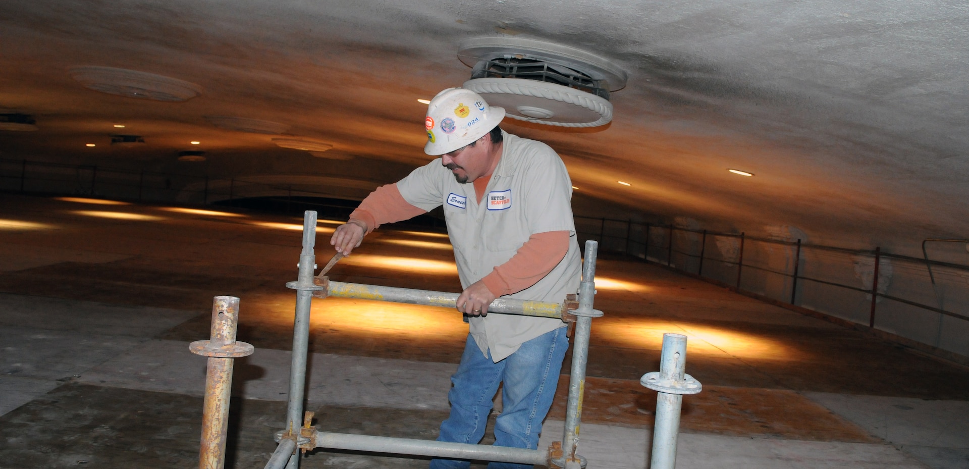 Ernest Cerda, a contractor with BETCO Scaffolding, assembles the framework for scaffolds so renovations can be performed on the ceiling at the base theater. (U.S. Air Force photo by Rich McFadden)