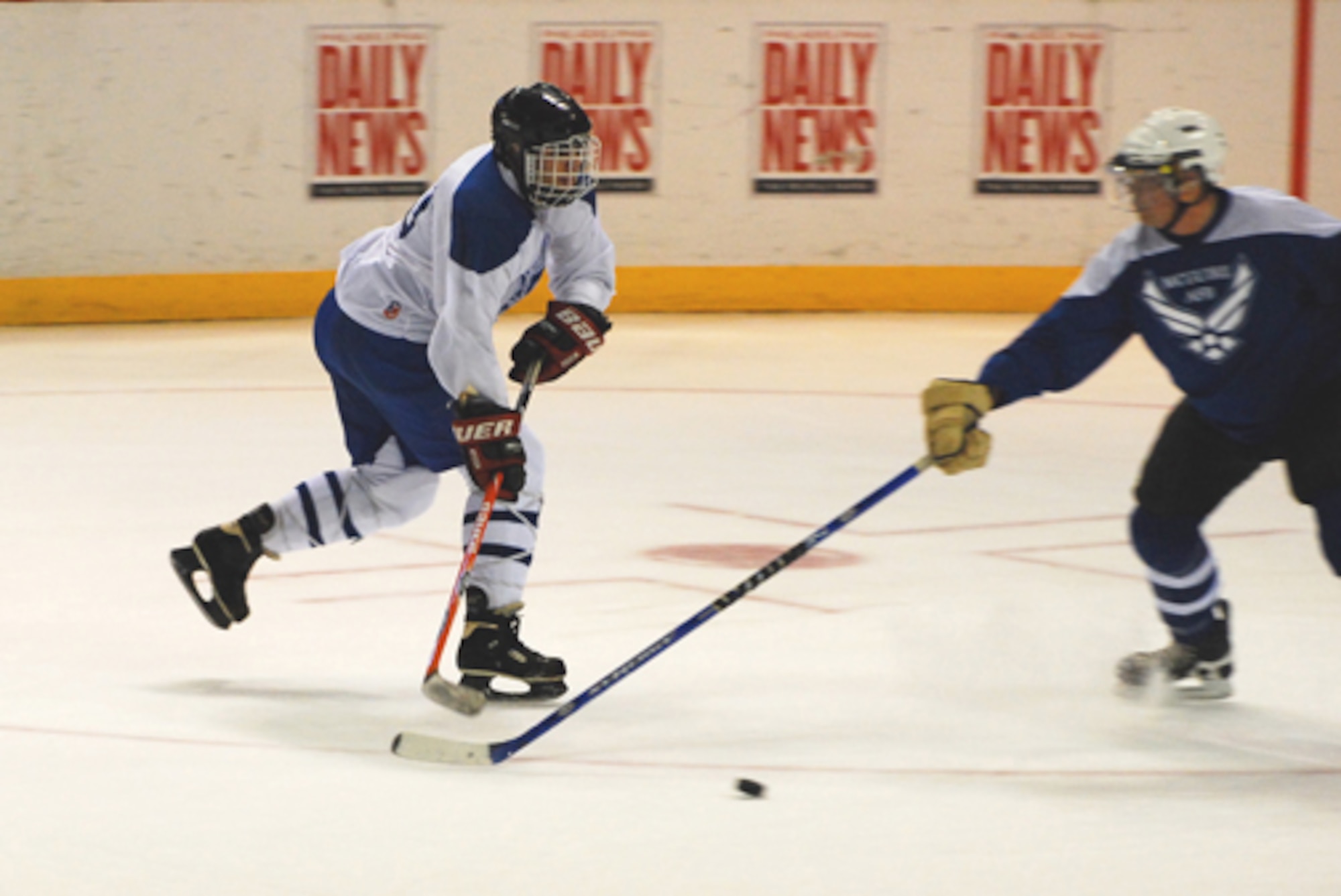 PHILADELPHIA, Pa. -- Dover's Lane Thurman, number 39, attempts to free the puck from a McGuire team member during the second annual all-star charity hockey match in Philadelphia Jan. 31. The game, held prior to the Philadelphia Phantoms match, ended with a 1-7 loss for Dover. Dover's team was comprised of active-duty, reservists and civilians from the 436th and 512th Airlift Wings. (U.S. Air Force photo/Staff Sgt. Steve Lewis)