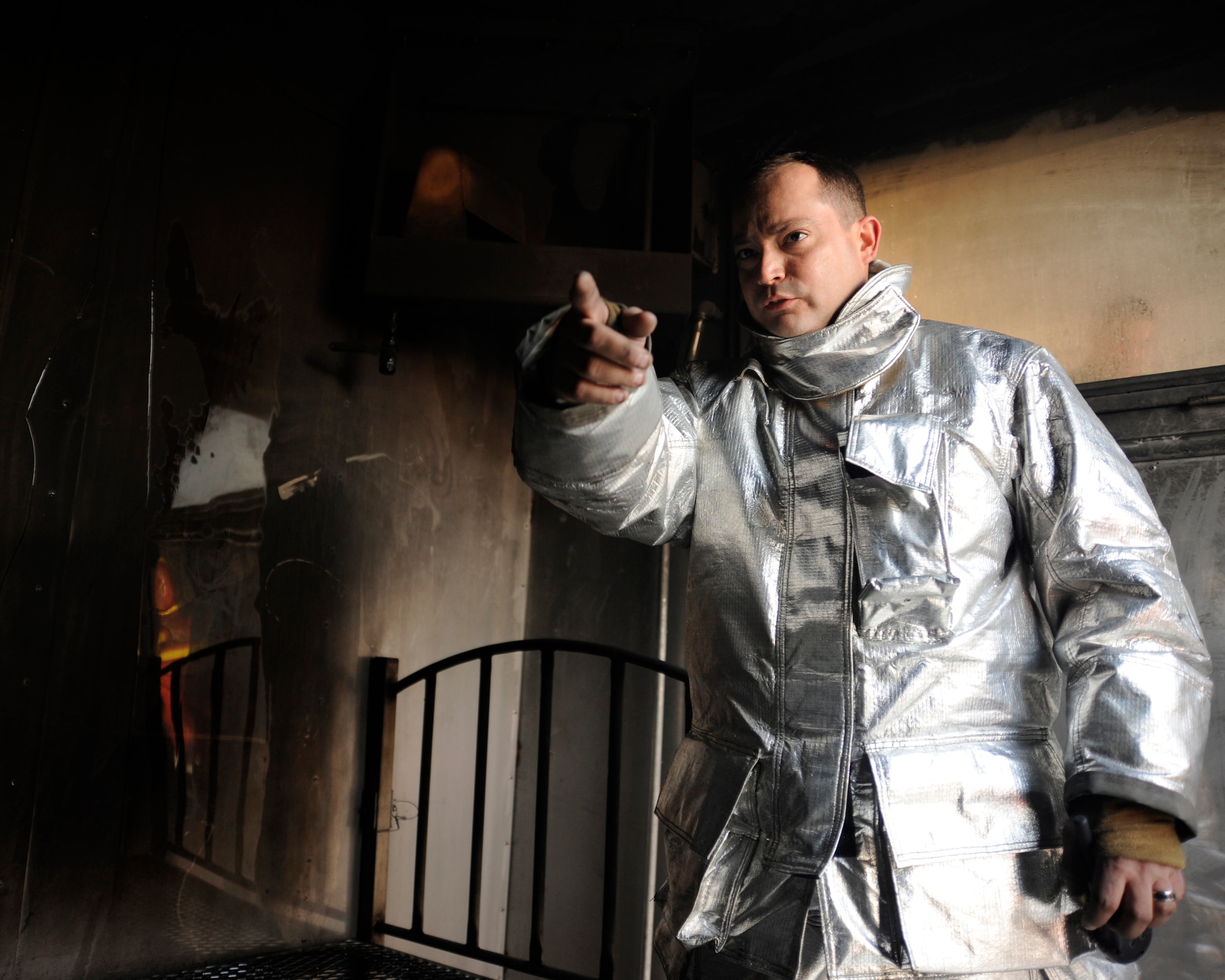 Tech. Sgt. Brian Partido, a fire and rescue advisor, explains the different features of the mobile live fire training unit in Baghdad, Iraq, Dec. 24, 2008. Partido is deployed from the 19th Civil Engineer Squadron, Little Rock Air Force Base, Ark. (U.S. Air Force Photo/Staff Sgt. Paul Villanueva II)