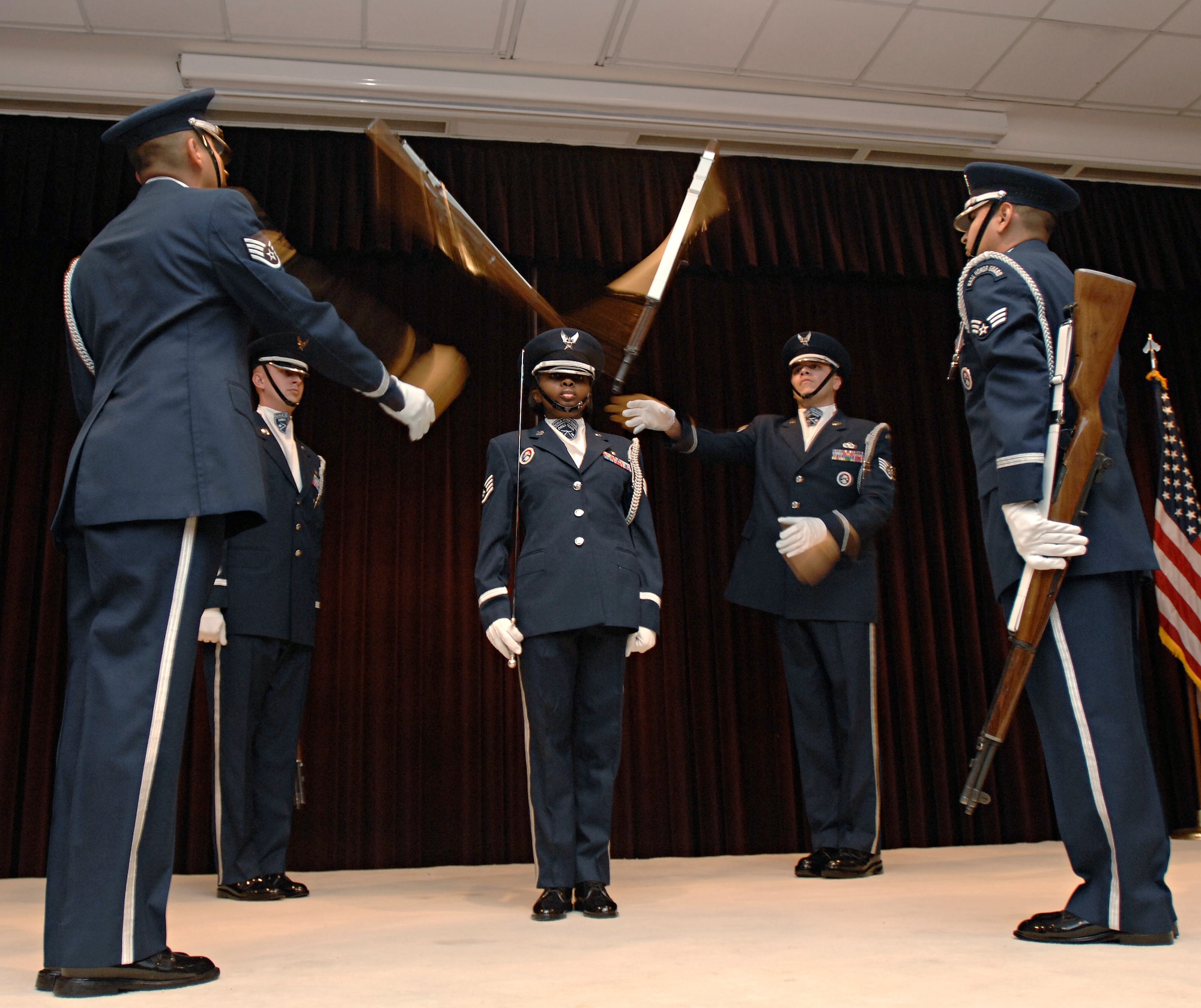 Incirlik Air Base drill team members toss rifles that narrowly miss their drill master as part of a special presentation during the 39th Air Base Wing annual awards banquet, Jan. 30. The annual awards banquet is held to honor the members of the wing that stood-out above their peers during the 2008 calendar year. (U.S. Air Force photo/Senior Airman Benjamin Wilson)