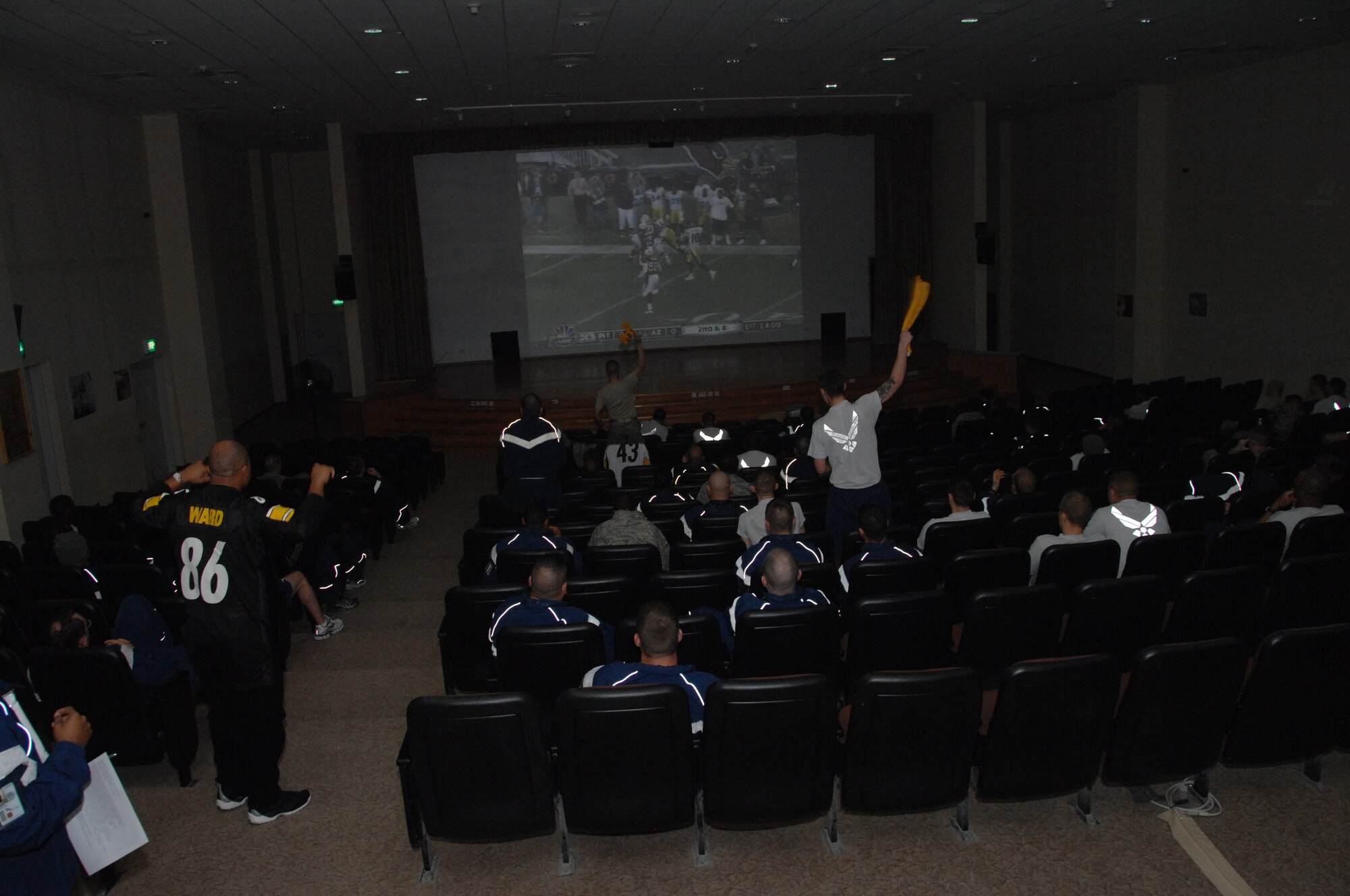 SOUTHWEST ASIA -- Personnel from the 386th Air Expeditionary Wing cheer for their team during the Super Bowl game between the Pittsburg Steelers and the Arizona Cardinals at the Rock Theater at an air base in Southwest Asia, Feb. 2.  (U.S. Air Force photo/Senior Airman Courtney Richardson)