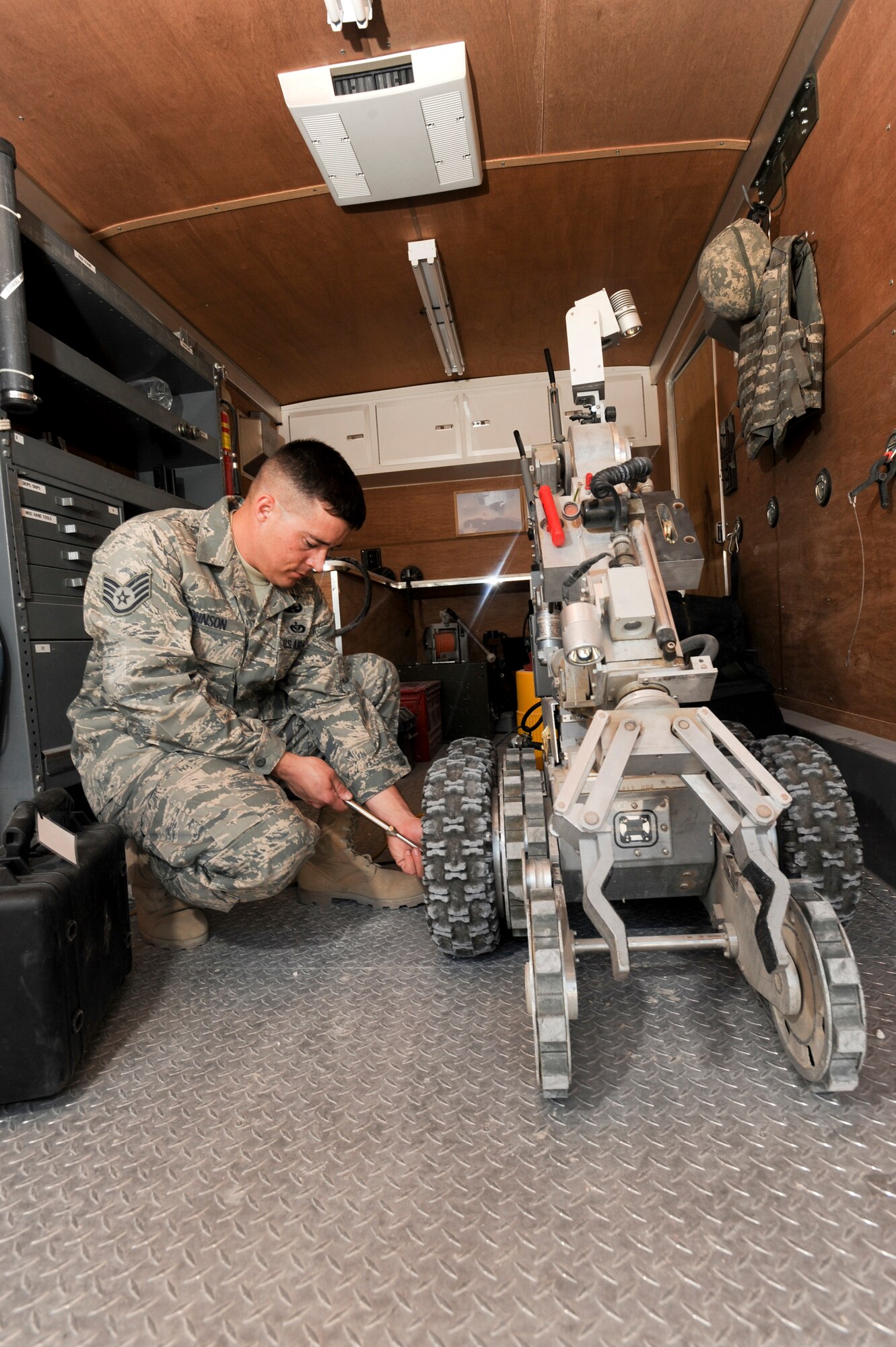 Staff Sgt. Macord Johnson, an Explosive Ordnance Disposal Technician with the 379th Expeditionary Civil Engineer Squadron, checks the tire pressure of an F-6 ANDROS robot, Jan. 30, 2009, in an undisclosed location in Southwest Asia. The F-6 ANDROS has the capability to act as a human arm when in the field. Sergeant Johnson hails from Las Vegas, Nev. and is deployed from an Active Reserve unit out of Nellis Air Force Base, Nev. in support of Operations Iraqi and Enduring Freedom and Combined Joint Task Force - Horn of Africa.  (U.S. Air Force Photo by Staff Sgt. Joshua Garcia/released)