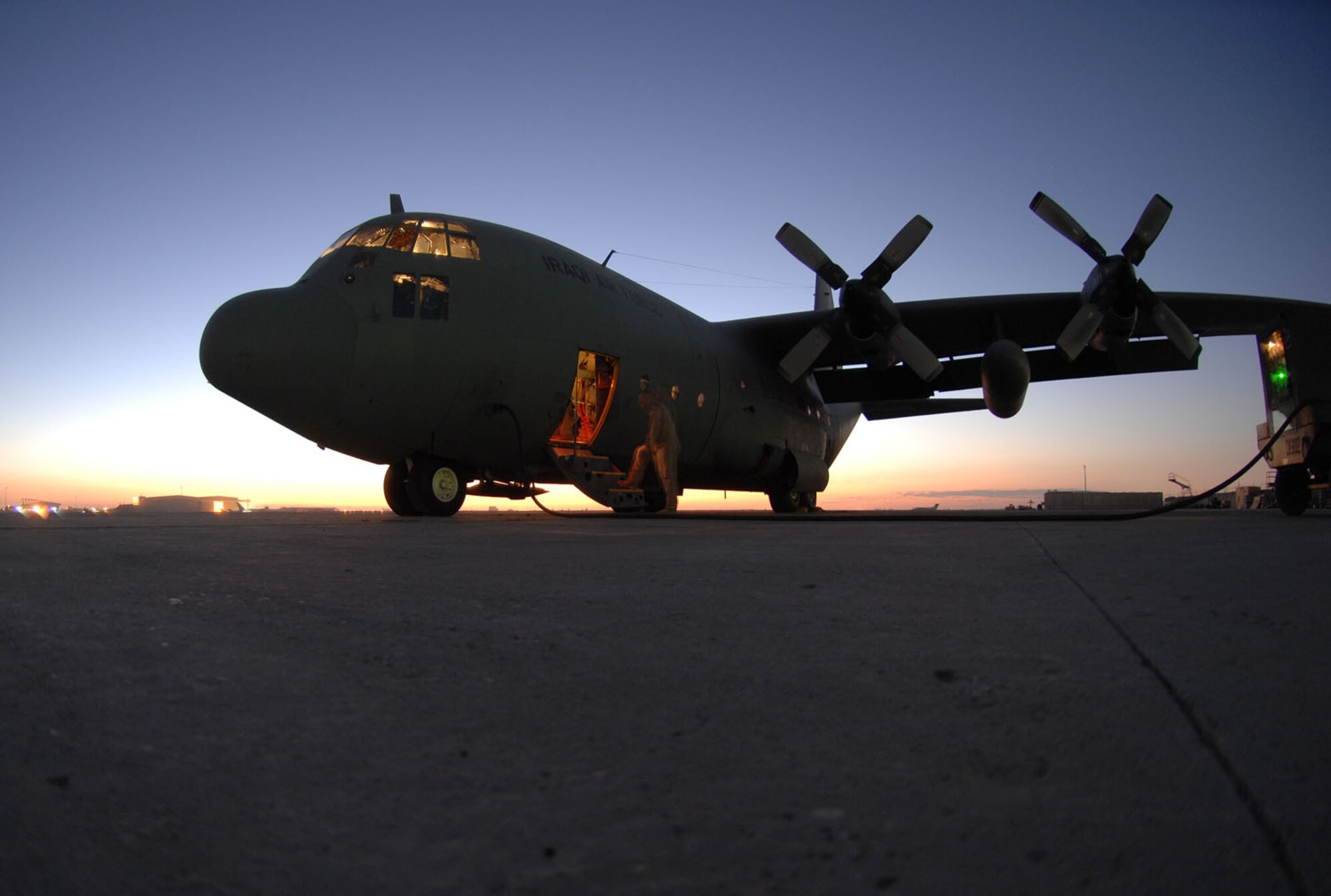 Master Sgt. Louis Carter, 321st Air Expeditionary Airlift Squadron combat aviation advisor, stands on the steps of an Iraqi C-130E after completing a pre-flight inspection here Feb.2. The C-130 was one of two aircraft on its way to pick up Iraqi election ballot boxes. Sergeant Carter is deployed from the 550th Special Operations Squadron at Kirtland Air Force Base, N.M. (U.S. Air force photo by Staff Sgt. Tim Beckham)