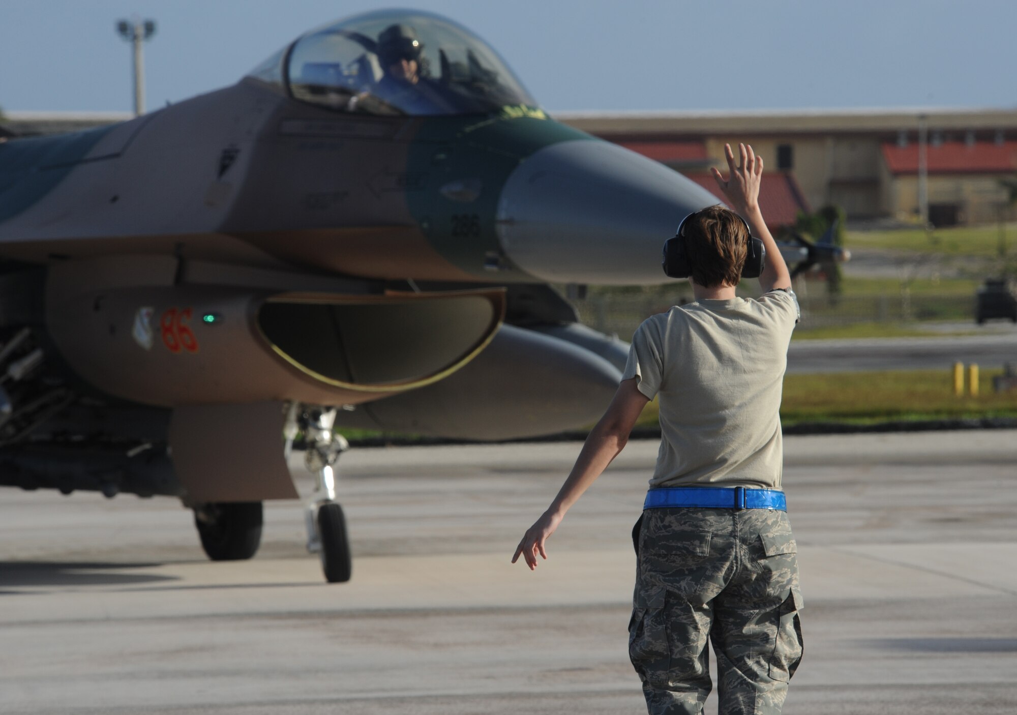 Senior Airman Sydney Reynolds, marshals in an F-16 Fighting Falcon, 18th Aggressor Squadron, Eielson Air Force Base, Alaska, after landing Jan. 31, at Andersen AFB, Guam for exercise Cope North 09-1 from 2-13 Feb. Japan Air Self Defense Force F-2s  from the 6th Squadron, Tsuiki Air Base and E-2Cs from the 601st Squadron, Misawa Air Base will join forward deployed USAF  F-16 Fighting Falcons from the 18th Aggressor Squadron, Eielson AFB Alaska, B-52 Stratofortress' currently deployed to Andersen AFB, Guam from the 23rd Expeditionary Bomb Squadron, and Navy EA-6B from VAQ-136 Carrier Air Wing Five, Atsugi, Japan will participate in this year's exercise with a focus on interoperability. Airman Reynolds is assigned to the 354th Aircraft Maintenance Squadron, Eielson AFB Alaska. 

(U.S. Air Force photo/ Master Sgt. Kevin J. Gruenwald) released





















  












 











































  












 

























