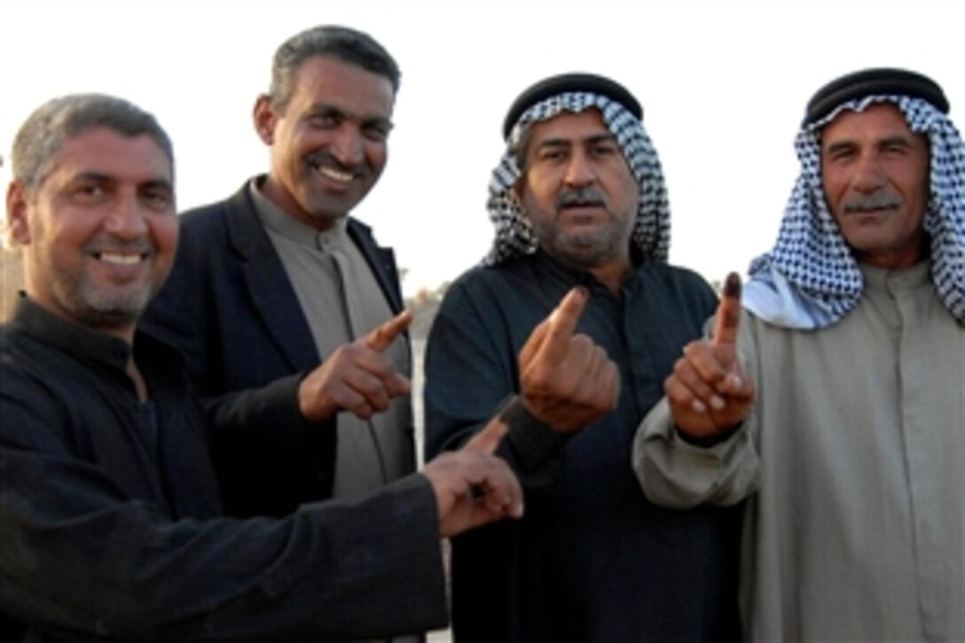 Several Iraqi men proudly display proof that they have voted outside a polling site in Jabella, Iraq, during the provincial elections in Babil Province on Jan. 31, 2009.
