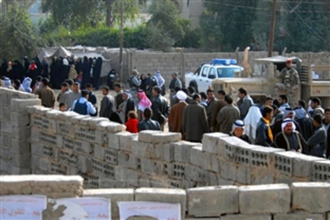 Iraqi citizens wait in line to vote at a polling site in Jabella, Iraq, during the provincial elections in Babil Province on Jan. 31, 2009.