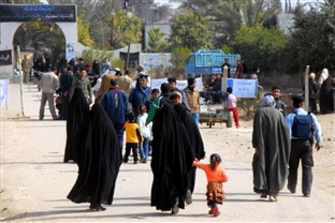 Iraqi citizens walk towards a polling site in Jabella, Iraq, to vote during the provincial elections in Babil Province on Jan. 31, 2009.