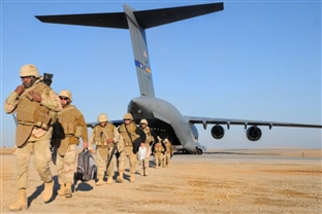 U.S. Navy Seabees assigned to Naval Mobile Construction Battalion depart an Air Force C-17 aircraft following its arrival on a forward operating base in Helmand province, Afghanistan, Jan. 28, 2009. The construction battalion is deployed to Afghanistan to provide construction support to forces supporting NATO International Security Assistance Forces.