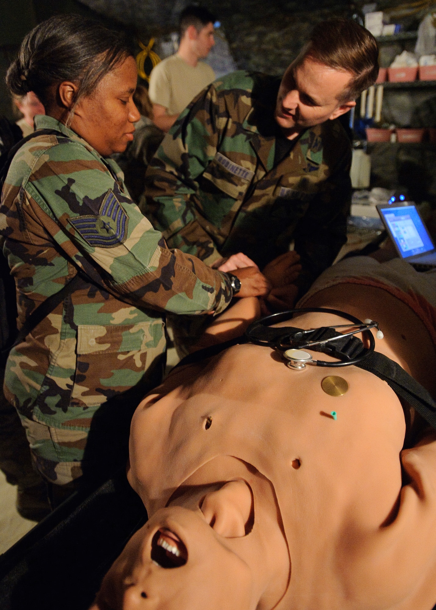Tech. Sgt. Shonteau Travis, medical technician 55th Medical Operations Squadron Offutt AFB, NE,  and Col. Tim Robinette (far left), 374th Medical Group commander Yokota Air Base, Japan, check the pulse of a METI iStan patient simulator during the Expeditionary Medical Support Course conducted by the U.S. Air Force school of Aerospace Medicine, Brooks City-Base, TX, Feb. 3. Students are introduced to the METI, iStan, patient simulator in preparation for the validation exercise during Expiditionary Medical Support Course training conducted by the US Air Force School of Aerospace Medicine. Controlled wirelessly by an instructor, the iStan patient simulator provides true to life anatomical articulation, the skin mimics human skin; real chest, heart and bowel sounds; the ability to excrete fluids; along with simulating jugular vein distention and bilateral chest movement. (U.S. Air Force photo/Steve Thurow)