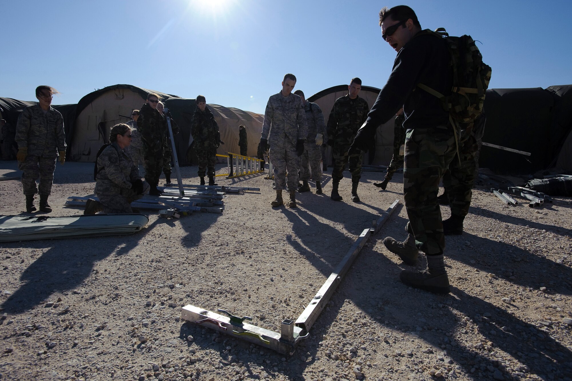 U.S. Air Force School of Aerospace Medicine, Expeditionary Medical Support Course instructors, go through the set up of an EMEDS portable hospital package with students during training Feb. 2. The tent build-up phase, during the first day of EMEDS, gives 374th Medical Group medics the skills required to deploy a basic EMEDS package within 24 hours of arriving at a deployed location. (U.S. Air Force photo/Steve Thurow)