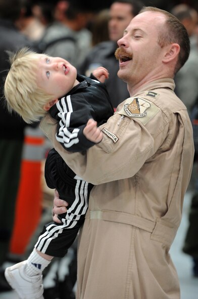 Capt. Steve Meissner, 34th Bomb Squadron B-1 Lancer pilot, plays with his son, Nathan, here, January 31. Captain Meissner was deployed for six months in support of Operations Iraqi and Enduring Freedom. (U.S. Air Force photo/Senior Airman Marc I. Lane)