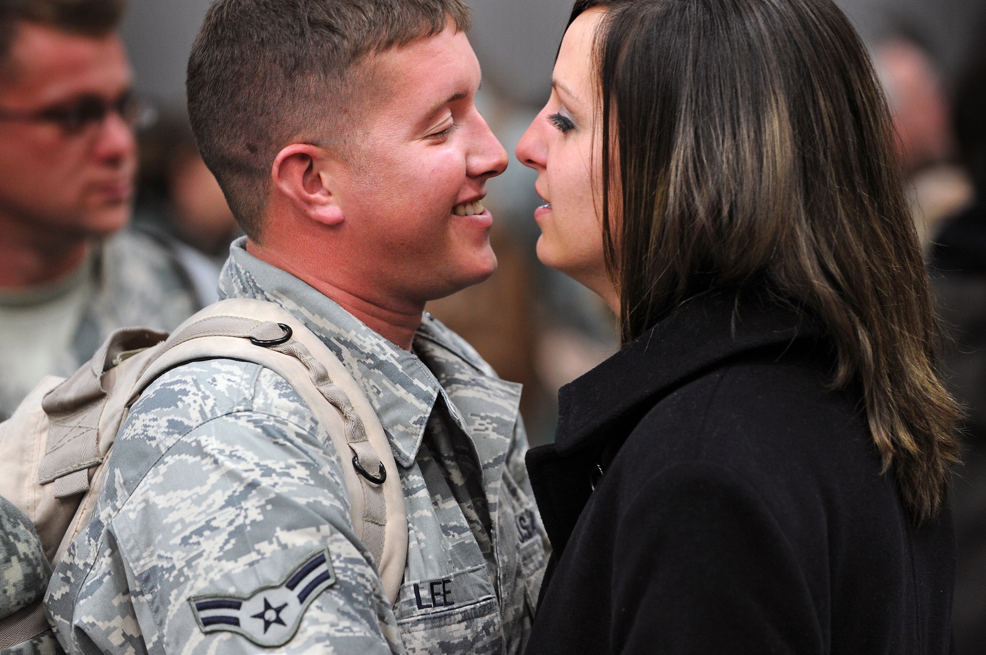 Airman 1st Class Chris Lee, 37th Bomb Squadron B-1 Lancer crew chief, hugs his girlfriend, Tami, here, January 31. Approximately 300 Airmen, serving in various roles, deployed to support Operations Iraqi and Enduring Freedom. (U.S. Air Force photo/Senior Airman Marc I. Lane)