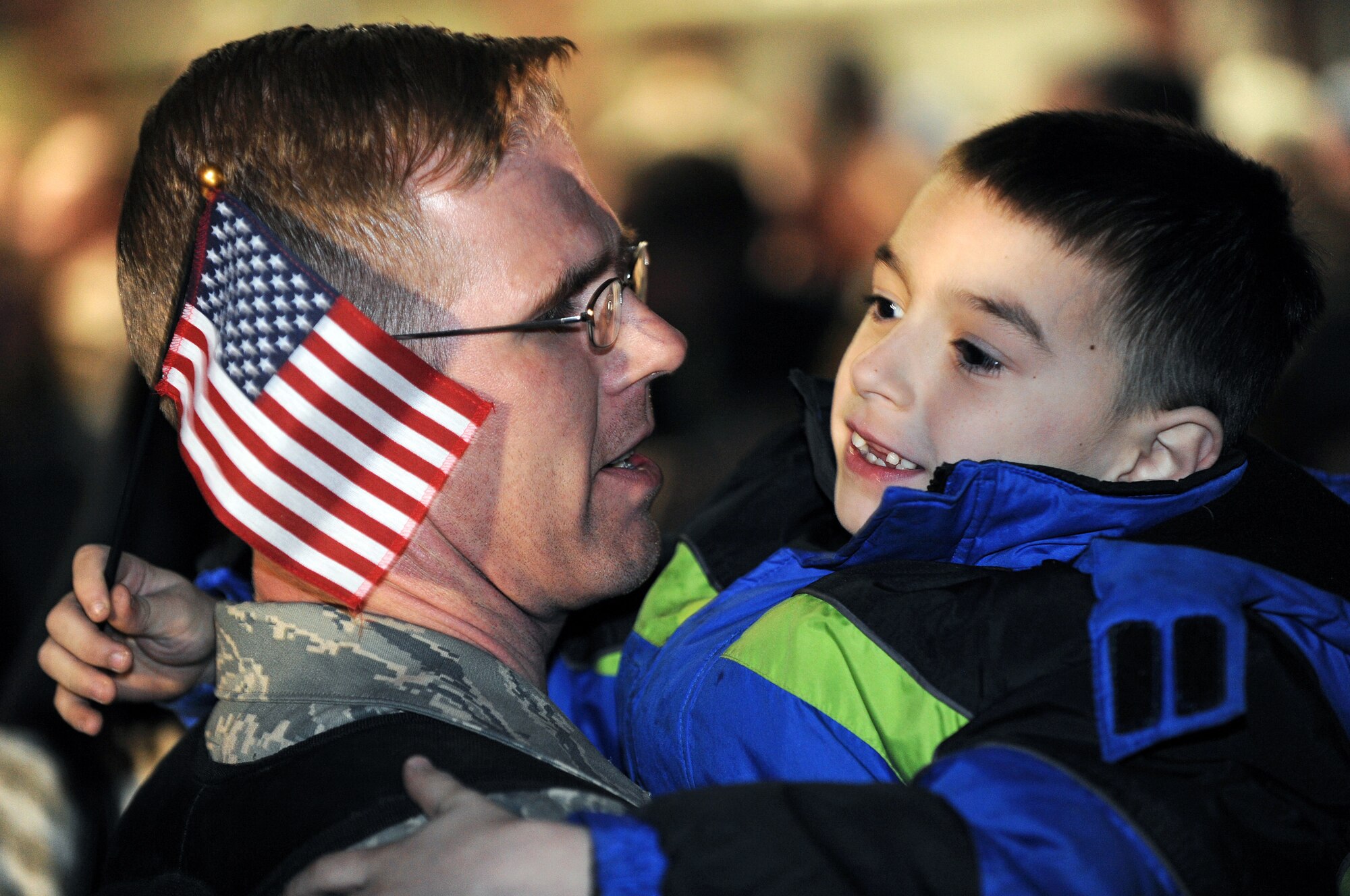 Tech. Sgt. Joe Jackson, 28th Munitions Squadron munitions controller, hugs his son, William, here, January 31. Approximately 300 Airmen, serving in various roles, deployed to support Operations Iraqi and Enduring Freedom. (U.S. Air Force photo/Senior Airman Marc I. Lane)