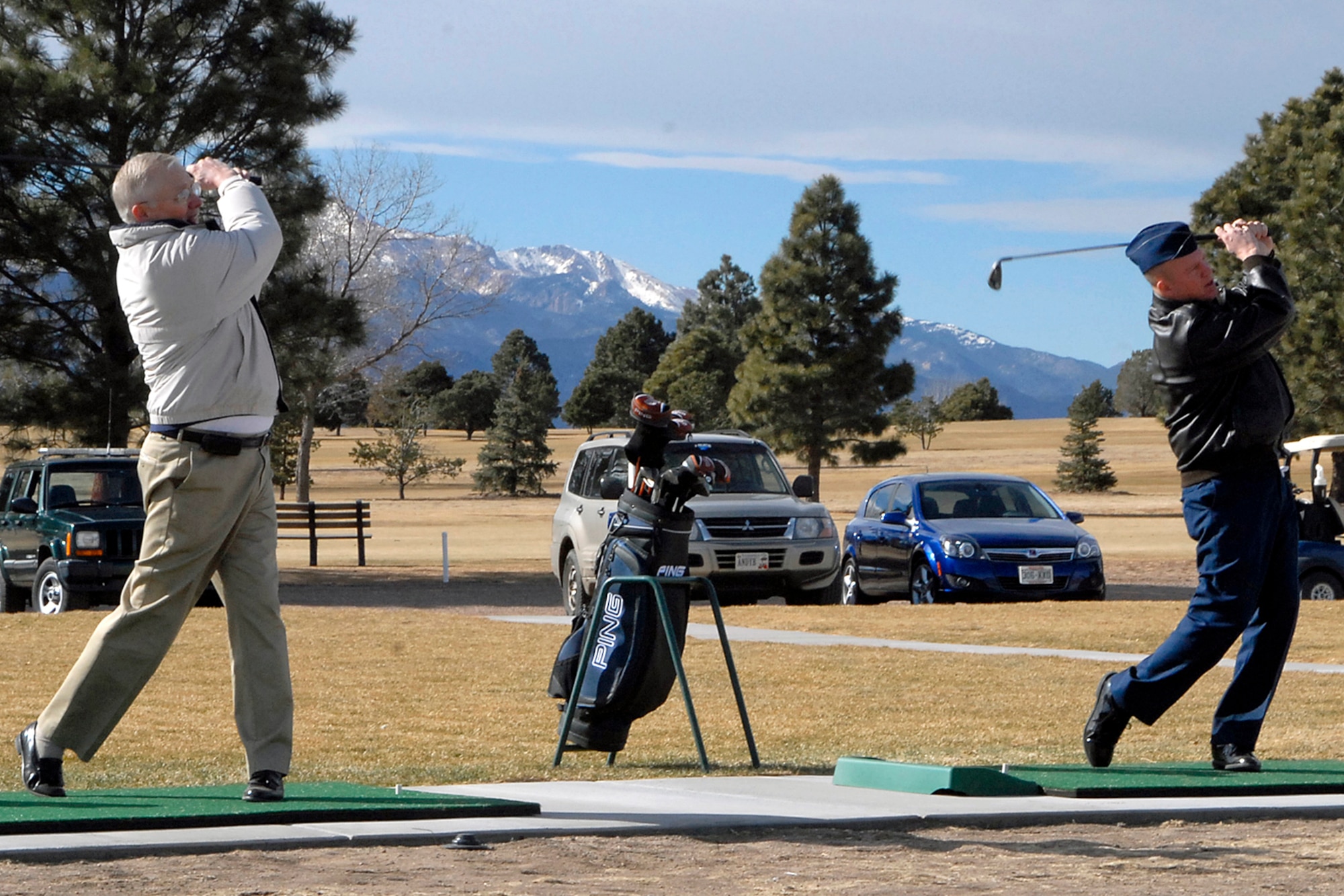 From left, Bob Mathis, vice president of Air Force Portfolio for Actus Lend Lease, and Col. Jay Raymond, 21st SW commander, hit the first golf ball of the season during Peterson AFB’s soft opening at the golf range, Feb. 2.