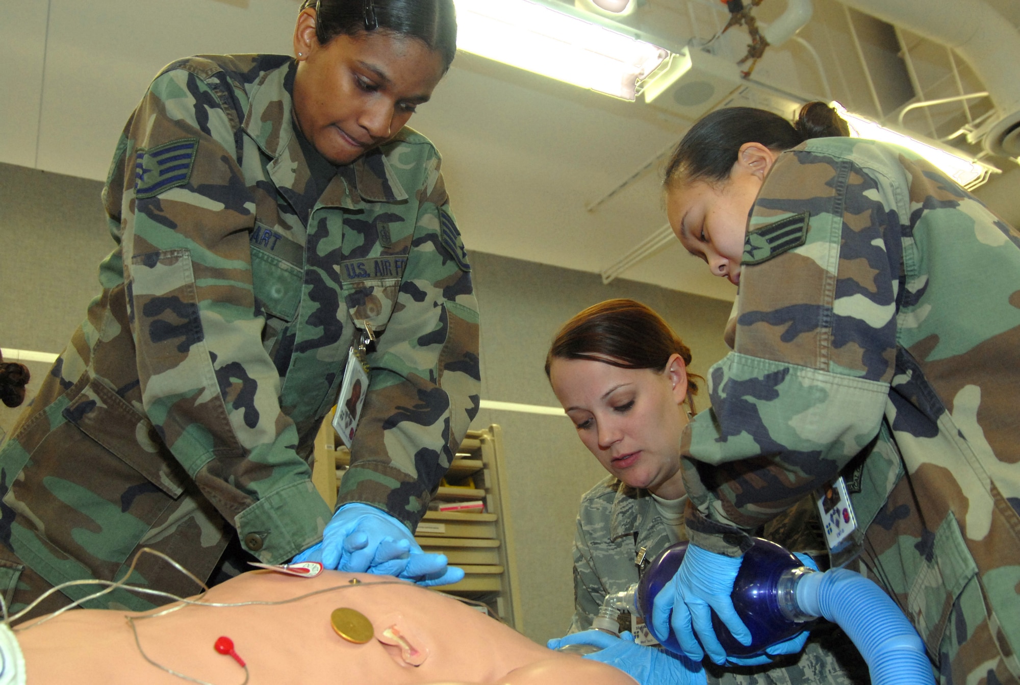 Medics with the 95th Medical Group provide an emergency medical care to a "Simulation Man" during a Paramedic Refresher Course Jan. 28. This is part of paramedic licensure recertification requirement. (Air Force photo by Senior Airman Julius Delos Reyes)