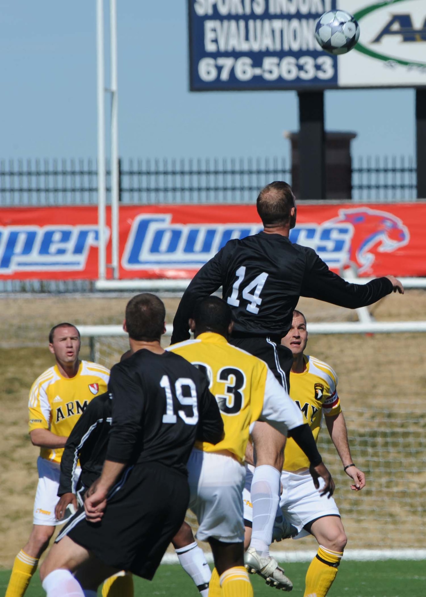 DYESS AIR FORCE BASE, Texas-- Air Force Capt. Jason Park number 14 executes a header during a match against the U.S. Army team at Shotwell Stadium, Feb. 2. The Army defeated the Air Force 1-0. (U.S. Air Force photo by Airman 1st Class Stephen Reyes)
