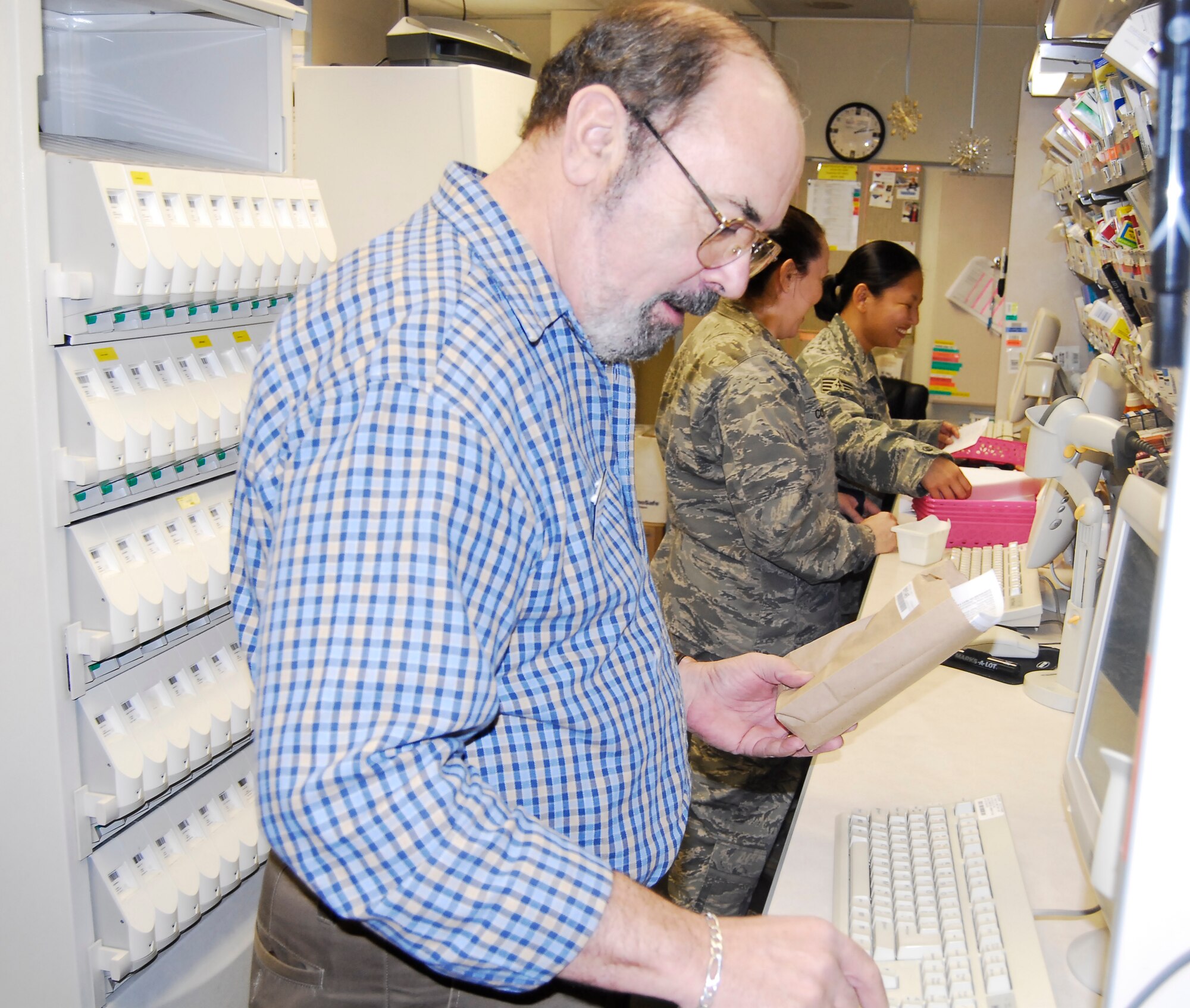 Rob Heye, a volunteer at the Pope clinic, prepares medication as part of his duties Feb. 3 at the pharmacy. Mr. Heye is a retired technical sergeant and has been volunteering at the pharmacy for more than seven years. Civilian volunteer opportunities provide a forum for retired military members to volunteer time and give back to their local base community. (U.S. Air Force Photo by Tech. Sgt. Todd Wivell)