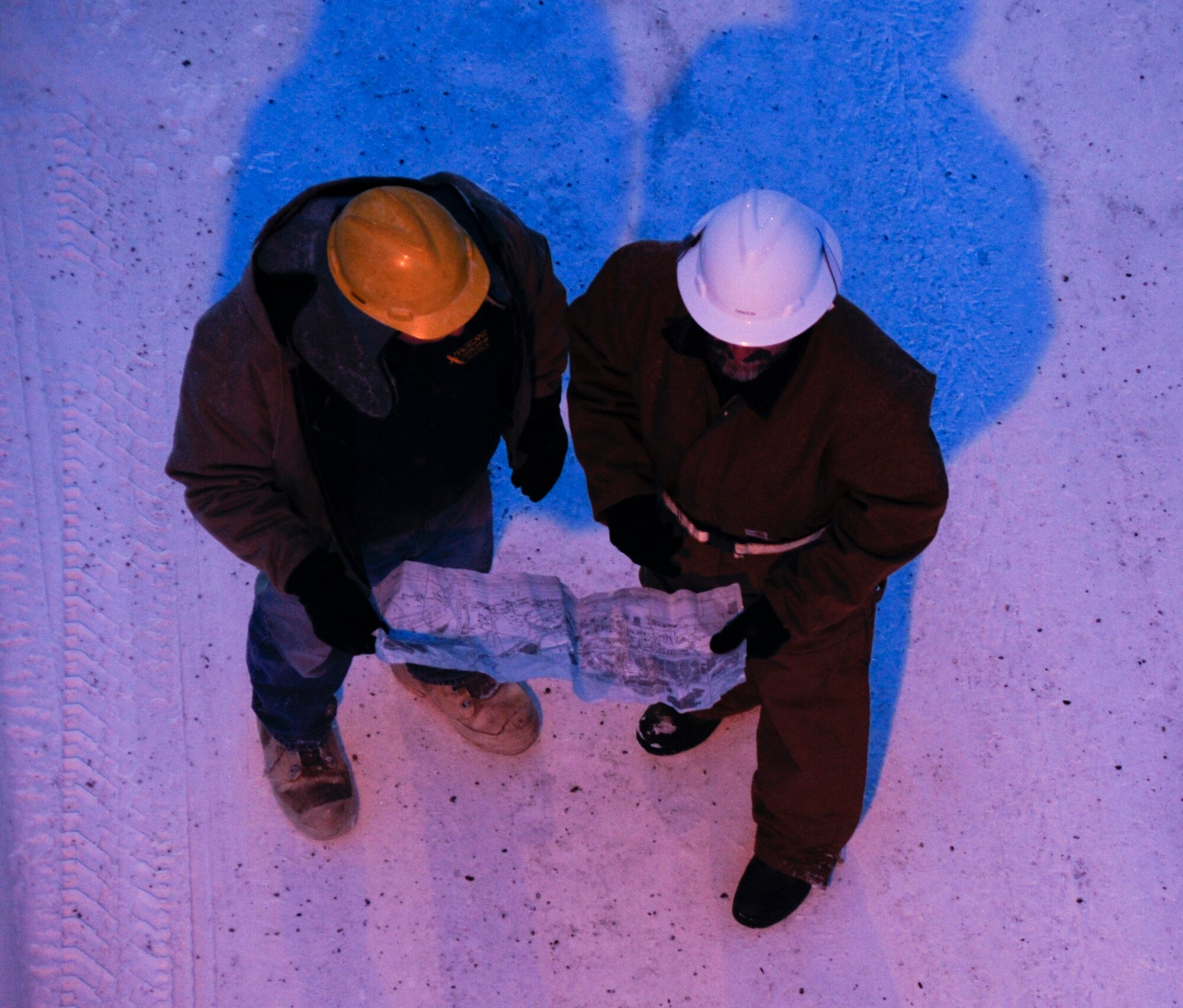 Mr. Robert Lynch and Mr. Jimmie Denton review a street light circuit map Feb. 2, 2009 at Eielson Air Force Base, Alaska. Mr. Denton is a high voltage supervisor and makes sure Airmen use the proper safety precautions before proceeding with scheduled maintenance.  (U.S. Air Force photo/Airman 1st Class Laura Max)
