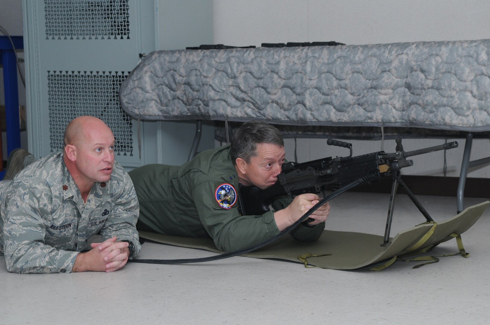 Maj. Gen. Gregory Feest (right) 19th Air Force commander, practices his aim as Maj. Frank Hellstern, 12th Security Forces Squadron commander, watches. General Feest visited several areas of the 12th Flying Training Wing Jan. 29-30 to learn more about the wing and its Airmen. (U.S. Air Force photo by Joel Martinez)