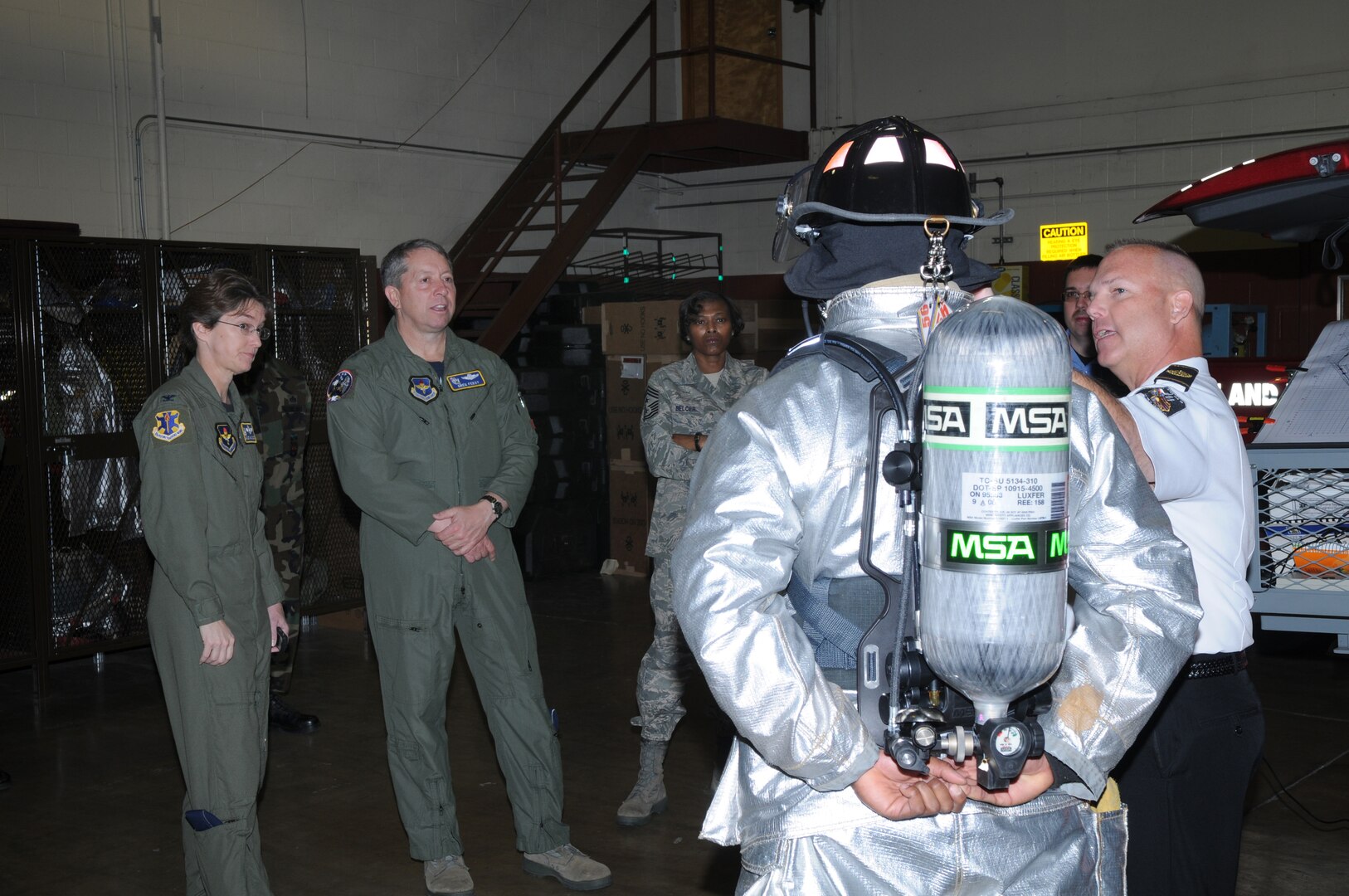 Col. Jacqueline Van Ovost, 12th Flying Training Wing commander, and Maj. Gen. Gregory Feest, 19th Air Force commander, visit with Randolph Fire Emergency Services personnel during a tour of the facilities. General Feest visited several areas of the 12th Flying Training Wing Jan. 29-30 to learn more about the wing and its Airmen. (U.S. Air Force photo by Joel Martinez)