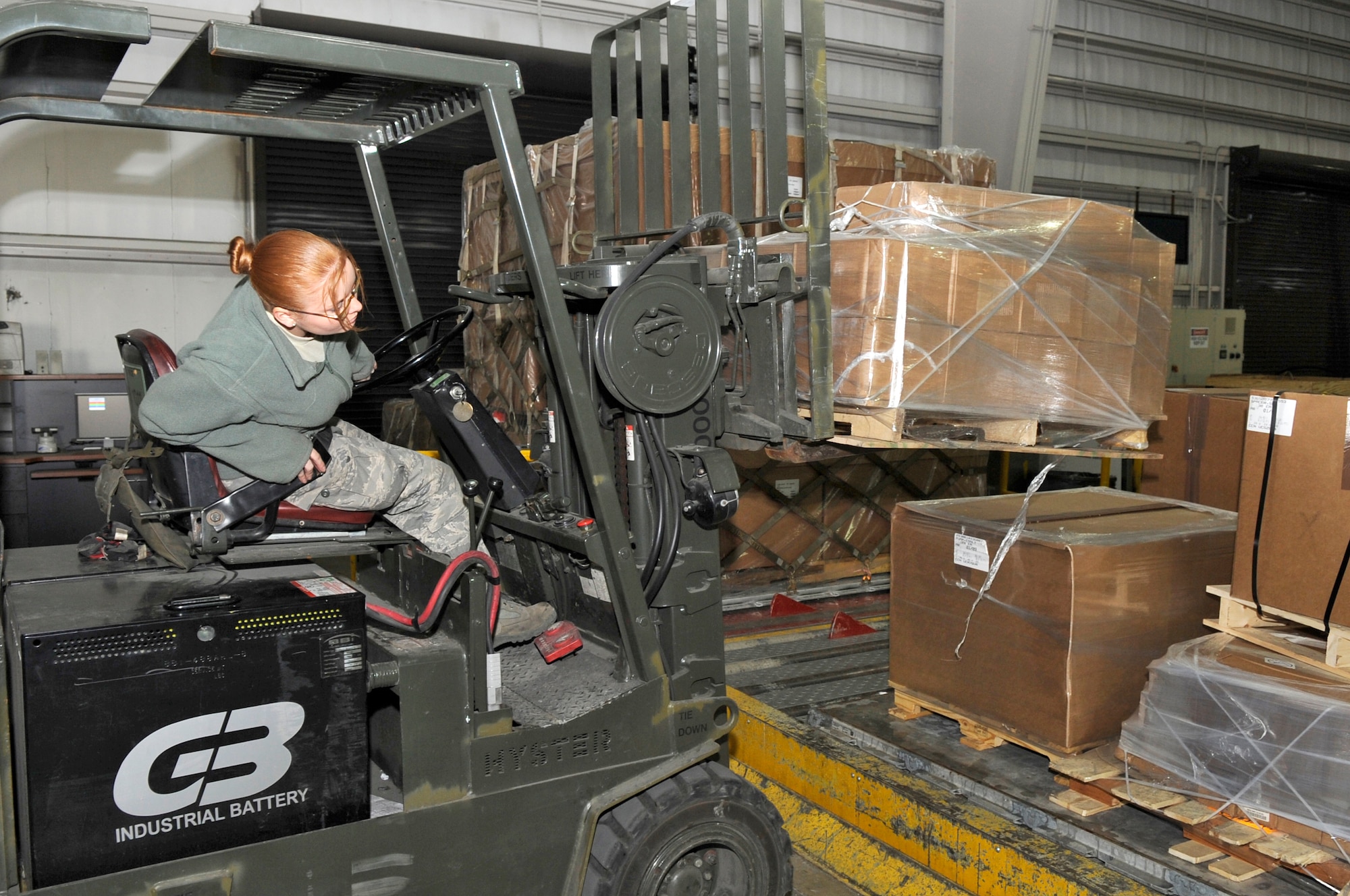 Airman Erica Hipwell, 305th Aerial Port Squadron air transportation apprentice, uses a forklift to move cargo onto large pallets Jan. 29. Once cargo is in-processed and scanned into the tracking system at the Transportation Management Office, it is moved by forklift over to the pallet pit to be prepared for shipping. (U.S Air Force photo/Carlos Cintron)