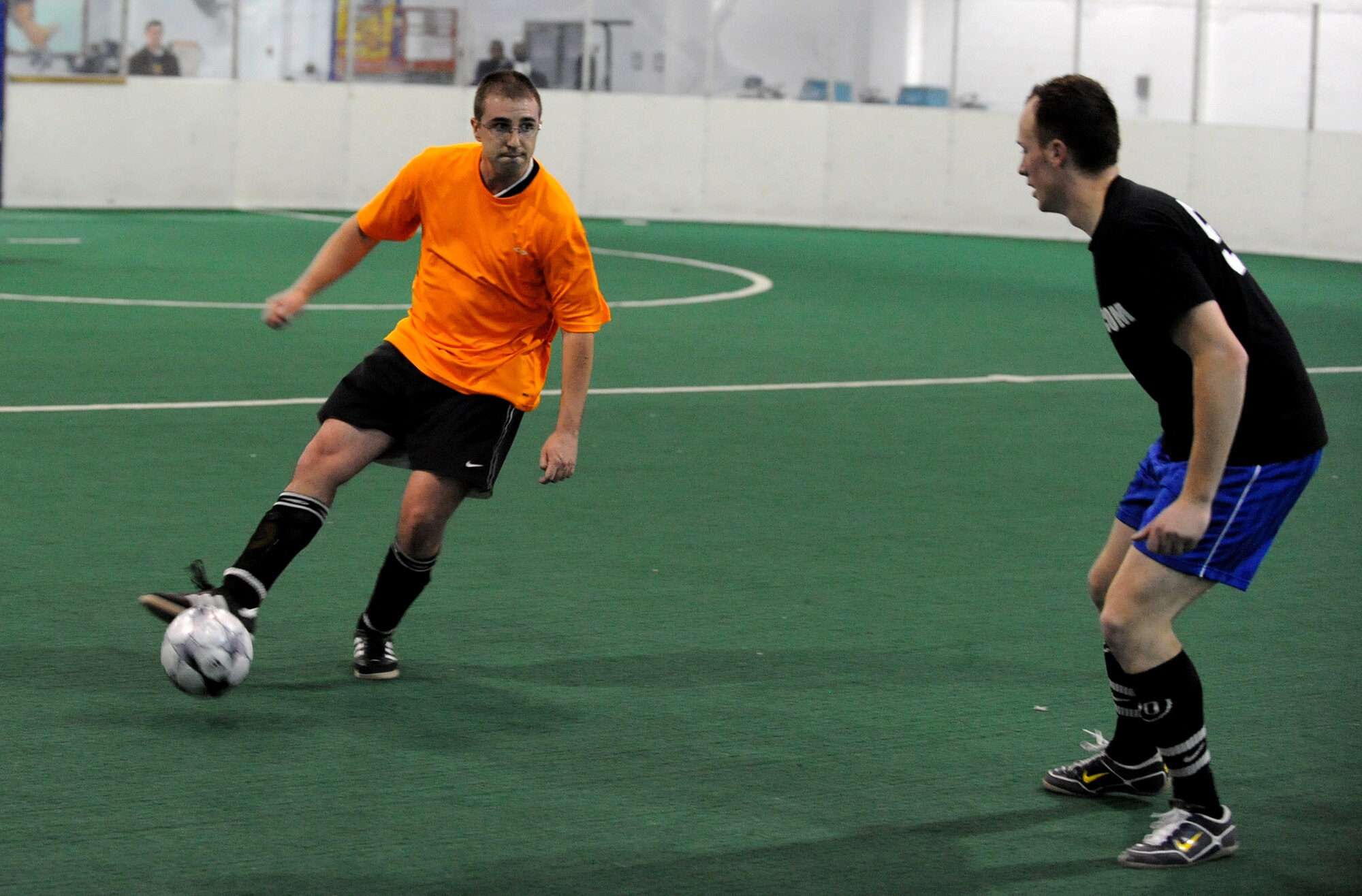 OFFUTT AIR FORCE BASE, Neb. -- Jason Gragan, 55th Communications Group, dribbles the ball past Andrew Smith, U.S. Strategic Command, during the intramural soccer championship game held at the Offutt Field House Feb. 2.  The intramural soccer league ended with STRATCOM defeating the 55th CG 4-1.

U.S. Air Force Photo by Josh Plueger

