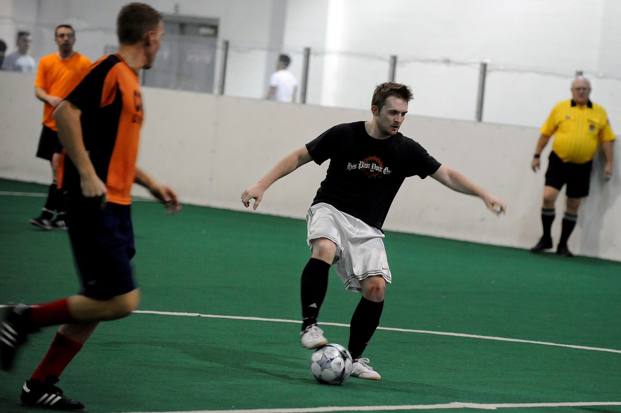 OFFUTT AIR FORCE BASE, Neb. --  Donald Bacon, U.S. Strategic Command, dribbles the ball through the 55th Communication Group defense during the intramural soccer championship game held at the Offutt Field House, Feb. 2.  The intramural soccer league ended with STRATCOM defeating the 55th CG 4-1.

U.S. Air Force Photo by Josh Plueger