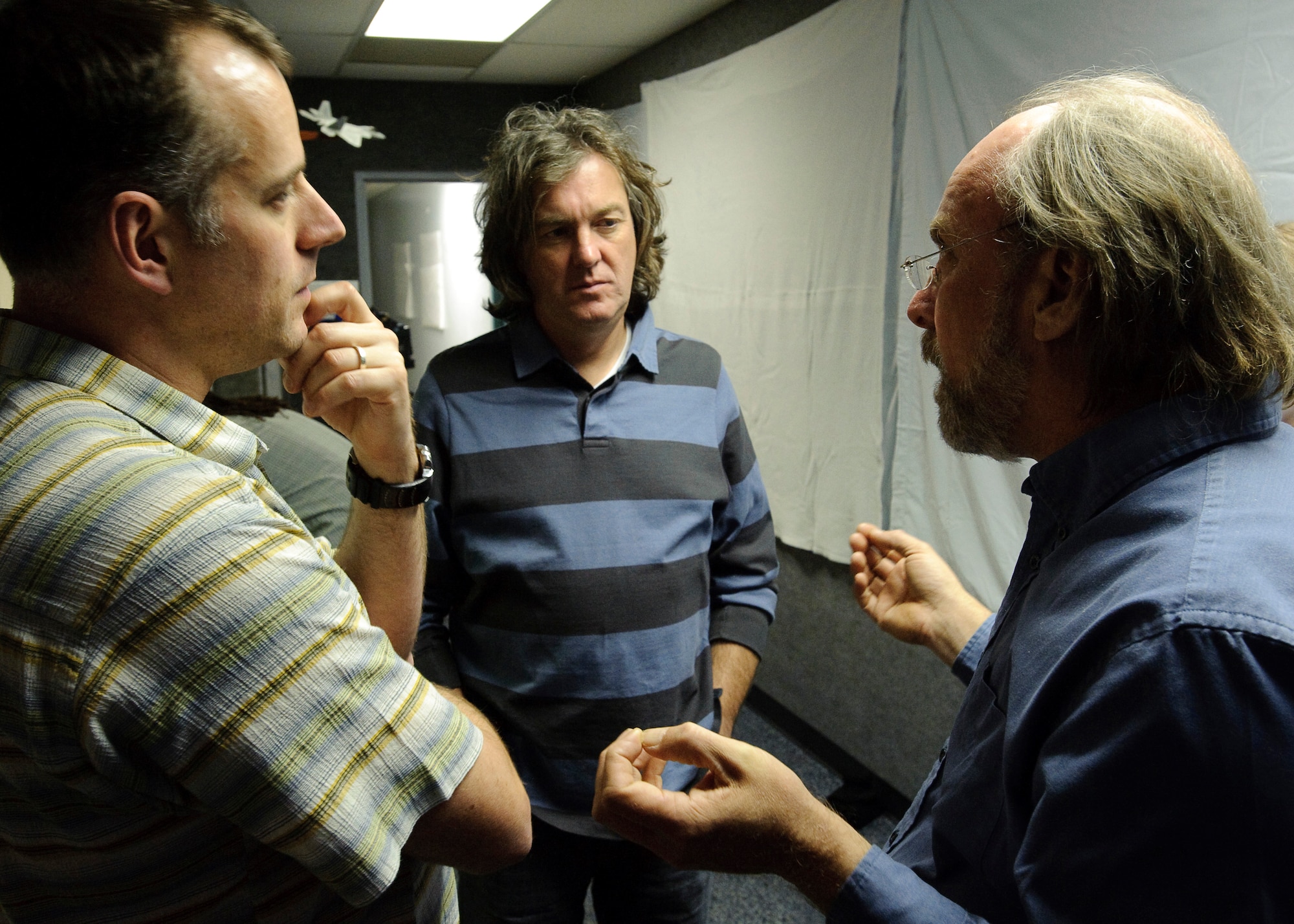 Wayne Isdahl (right) with the Air Force Research Laboratory Centrifuge discusses the mission profile of the Apollo 11 lunar mission during take-off with James May (center), BBC Presenter and Paul King (left), BBC Producer, during production of a documentary by BBC, James May on the Moon which commemorates the 40th anniversary of the Apollo 11 mission, the first to put a man on the Moon. May was spun to several Gs in the AFRL Centrifuge at Brooks City-Base, TX.  His experience allowed  him to be more familiar with the experiences of Apollo 11 Astronauts Neil Armstrong, Michael Collins, and Edwin E. Aldrin, Jr., during the initial phase of launch which entered orbit of the Earth 12 minutes after takeoff. 
 (US Air Force photo/Steve Thurow)