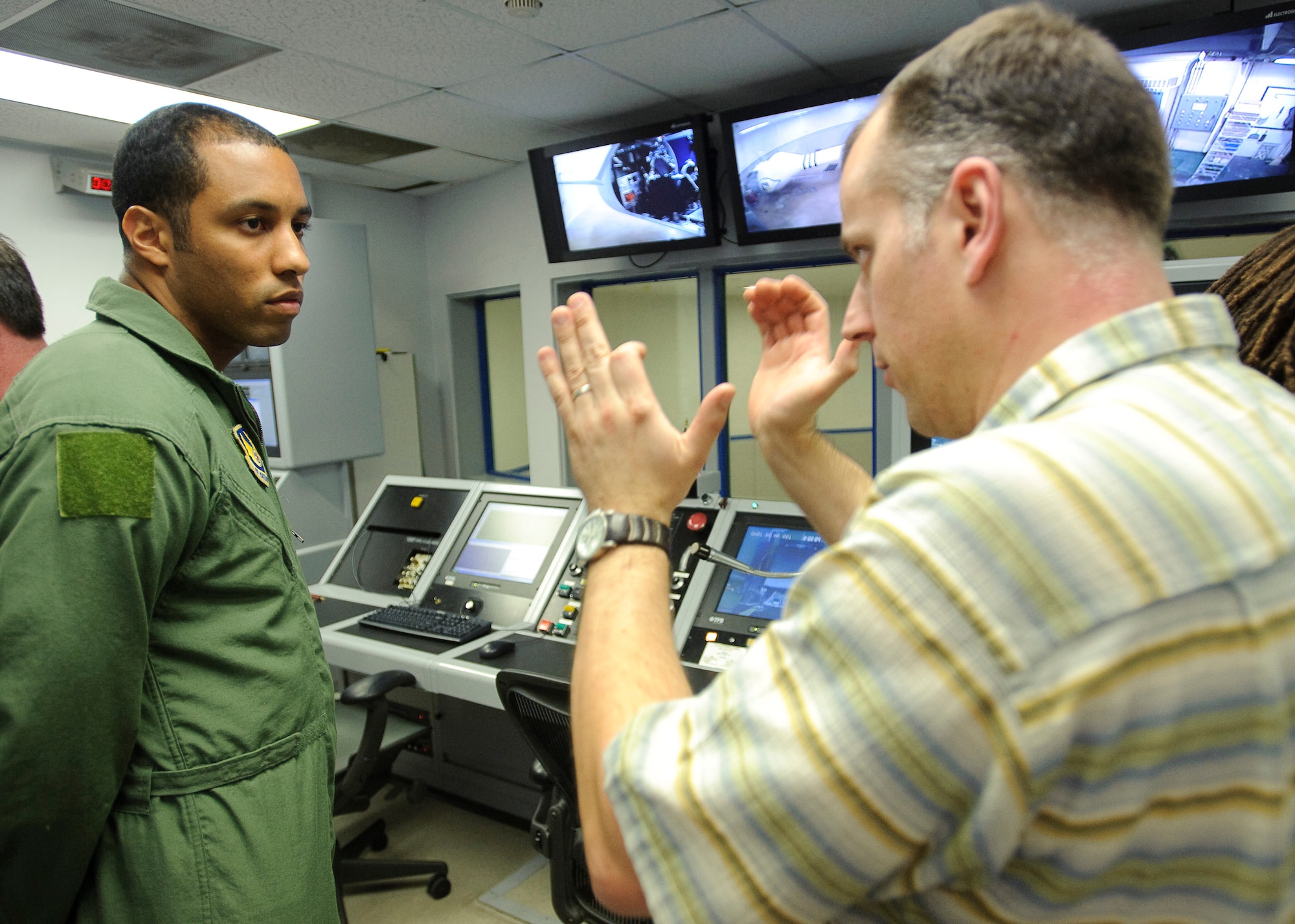 BBC Producer Paul King, right, directs  Staff Sgt. Andre Scott, Aerospace Physiology Technician with the Air Force Research Laboratory, during production of a documentary by BBC, which commemorates the 40th anniversary of the Apollo 11 mission, the first to put a man on the Moon.  James May was spun to several Gs in the AFRL Centrifuge at Brooks City-Base, TX.  His experience allowed  him to be more familiar with the experiences of Apollo 11 Astronauts Neil Armstrong, Michael Collins, and Edwin E. Aldrin, Jr., during the initial phase of launch which entered orbit of the Earth 12 minutes after takeoff.  (US Air Force photo/Steve Thurow)
