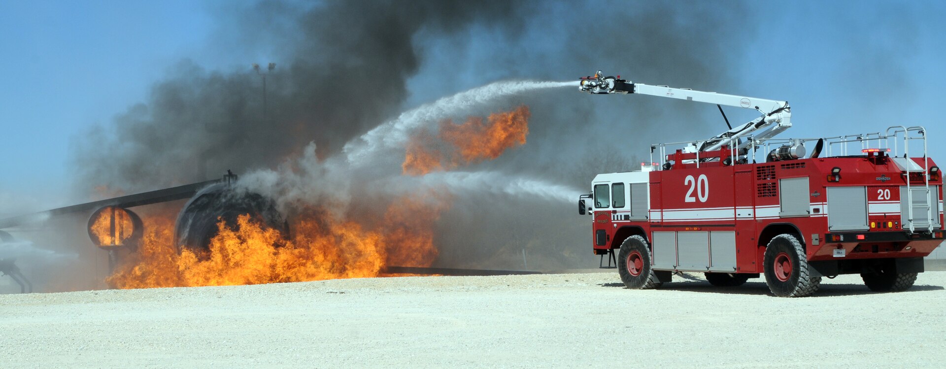 A Randolph Fire Emergency Services vehicle demonstrates how to extinguish an aircraft fire during a training session at the fire training facility here Feb. 1. Several local fire departments visited Randolph to train on proper response procedures to downed 12th Flying Training Wing aircraft in the event one crashed in their city. (U.S. Air Force photo by Steve White)