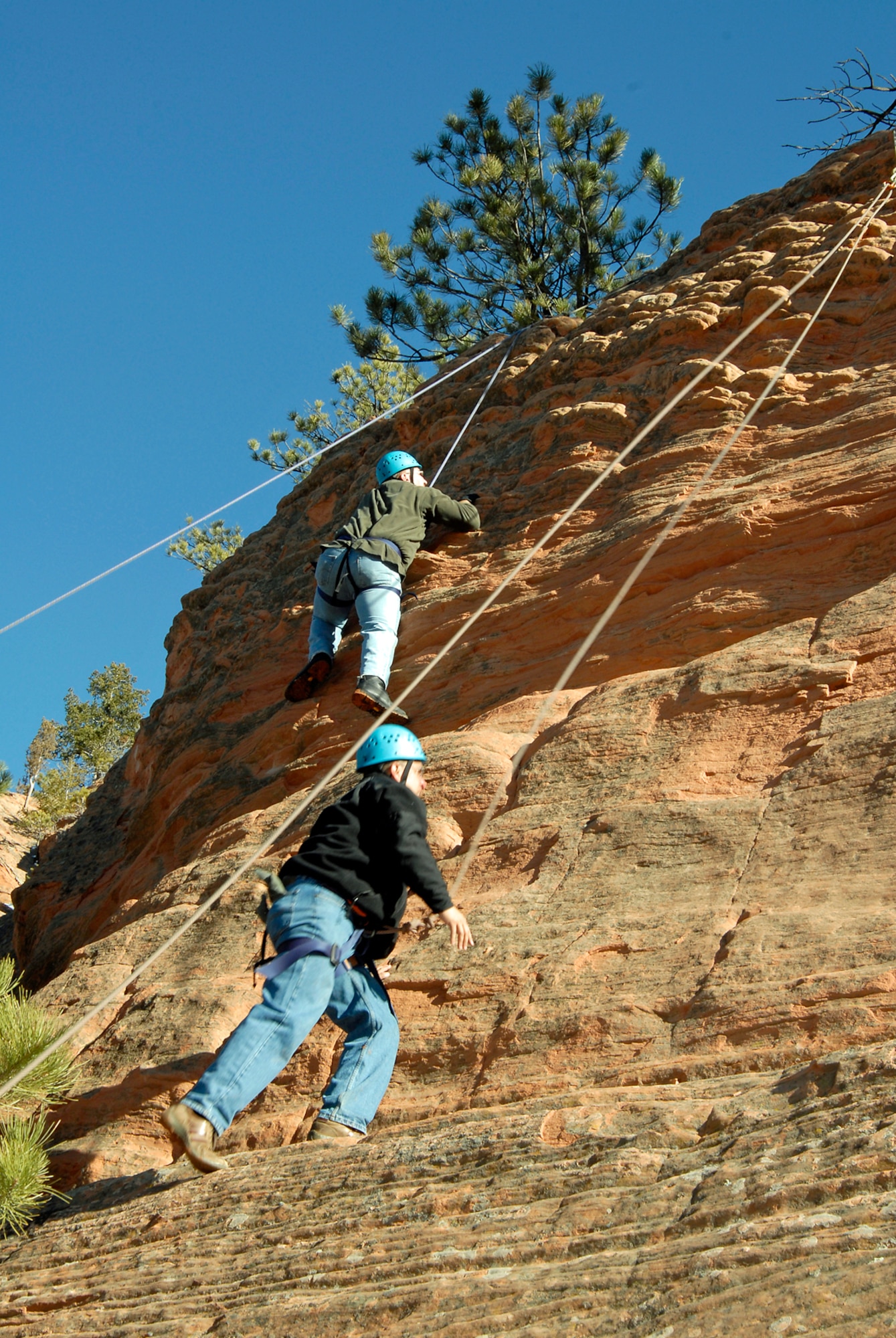 (Left to right) Tech. Sgt. Lyn Witte, 21st Operations Group and Master Sgt. Julio Flores, 21st Space Wing, build teamwork and trust through rock climbing at Red Rocks Canyon in Colorado Springs. (Air Force photo/ Roberta McDonald)