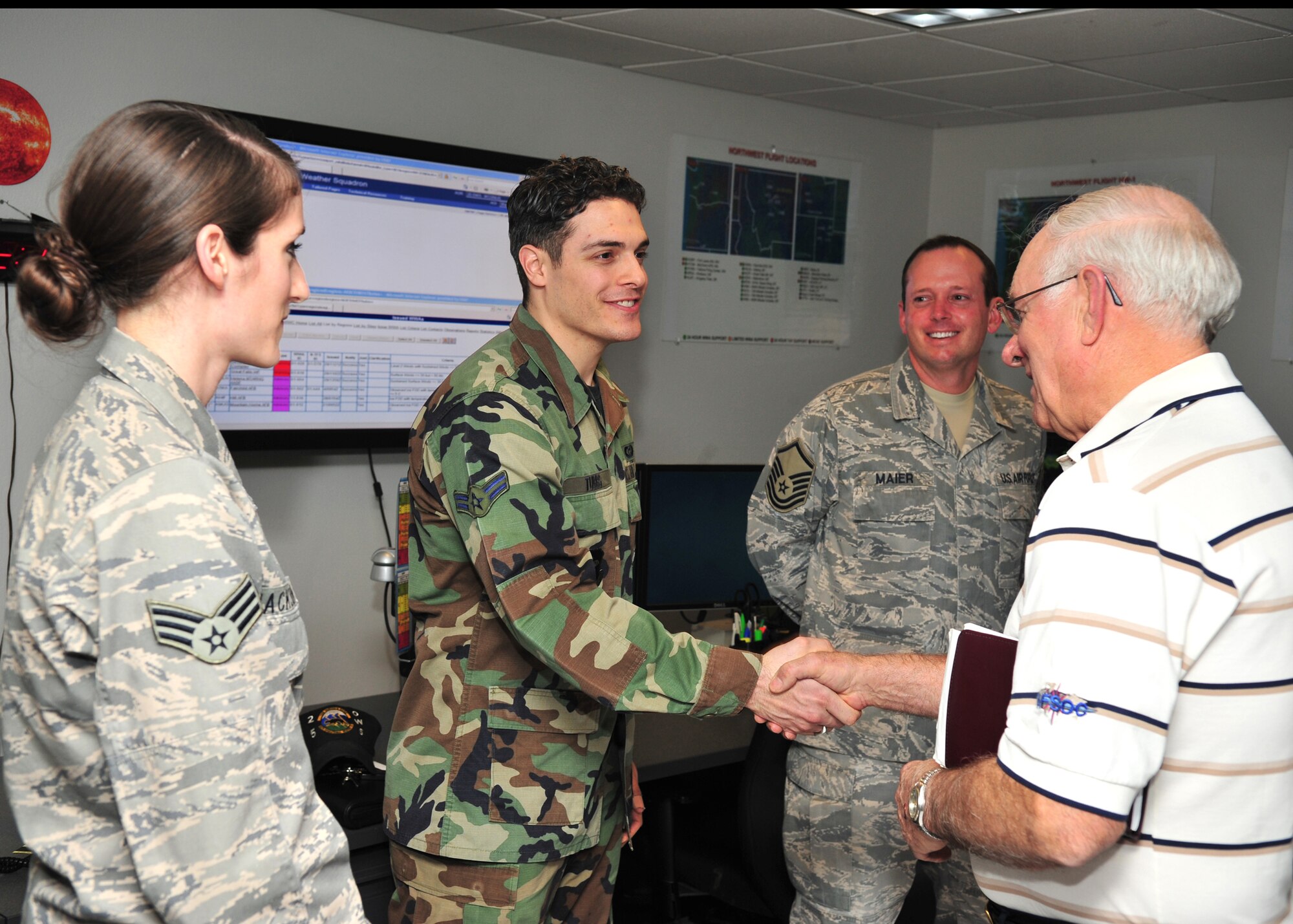 Retired Chief Master Sgt. of the Air Force Sam Parish speaks with Airman 1st Class Brian Tubbs of the 25th Operational Weather Squadron here Jan. 29. (U.S. Air Force photo/Senior Airman Noah R. Johnson)