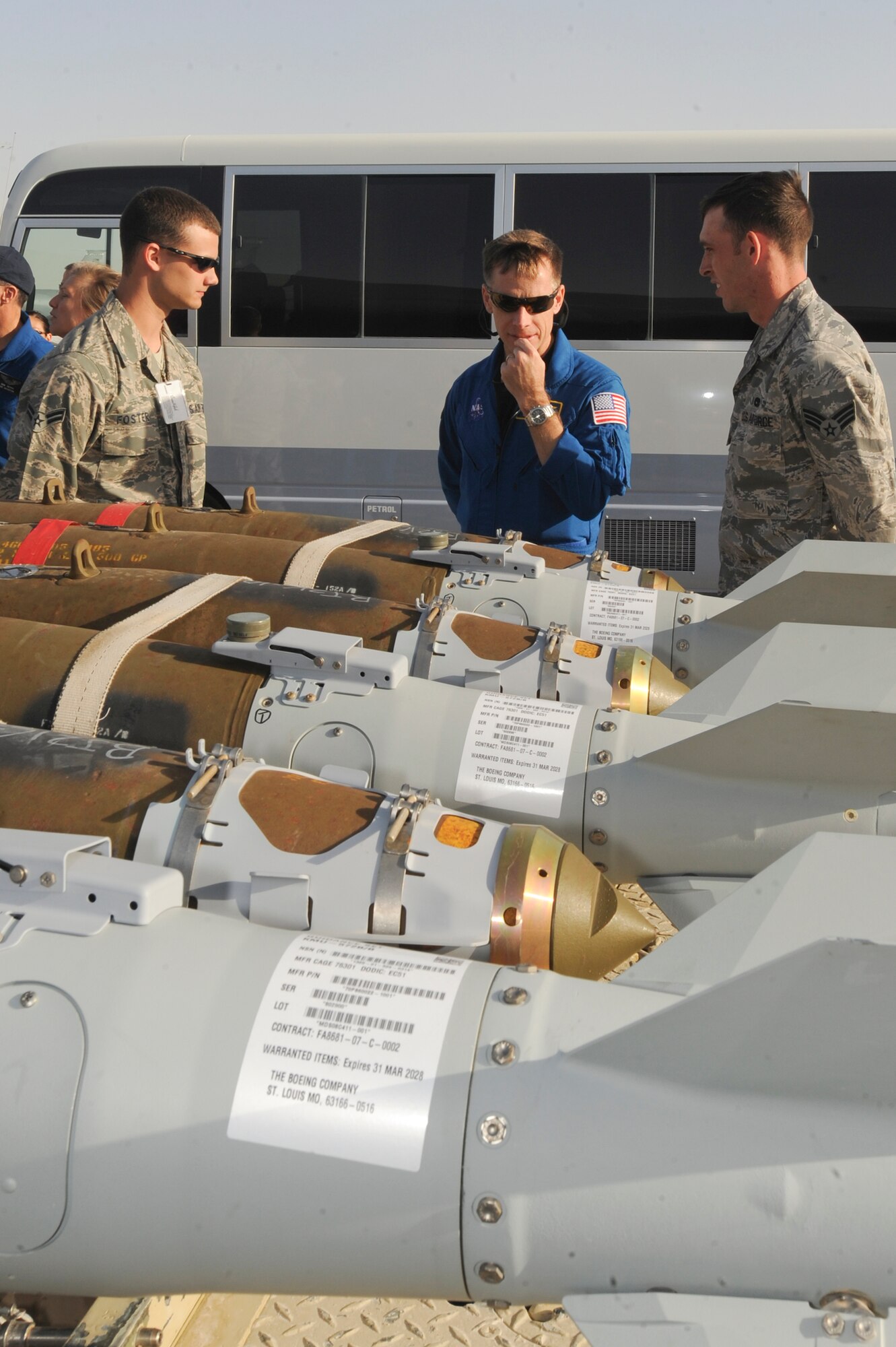 Airman 1st Class Brian Foster and Senior Airman Brandon Mullenix, Munitions Technicians from the 379th Expeditionary Maintenance Squadron, brief  the capabilities of the Guided Bomb Unit-38 to United States Navy Captain Christopher Ferguson, a NASA Astronaut, Feb. 2, 2009, in an undisclosed location in Southwest Asia.  The Astronauts from the Endeavour STS-126 mission were on base to visit with Airmen of the 379th Air Expeditionary Wing and its Coalition Partners as part of a Armed Forces Entertainment Tour.  Airman Foster is native to Ellijay, Ga. and Airman Mullenix hails from Angleton, Texas. Both are deployed from Dyess Air Force Base, Texas in support of Operations Iraqi and Enduring Freedom and Combined Joint Task Force - Horn of Africa. (U.S. Air Force Photo by Staff Sgt. Joshua Garcia/released)