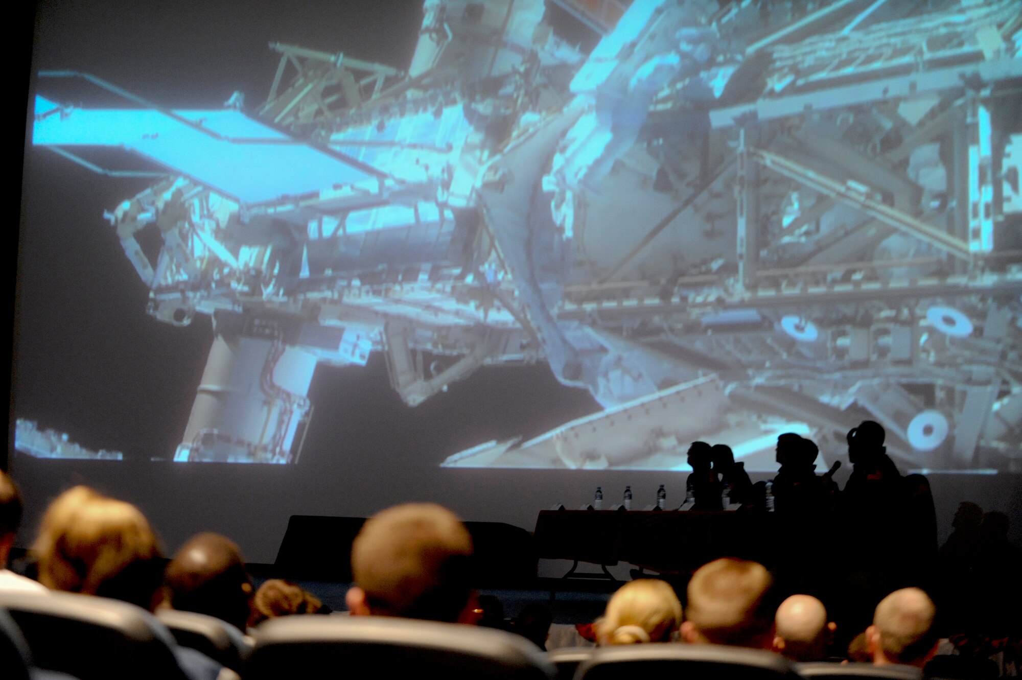 Members of the 379th Air Expeditionary Wing watch a video during a question and answer session with Astronauts from the recent Endeavour STS-126 mission in the base theater, Feb. 2, 2009, in an undisclosed location in Southwest Asia. The video captured the various aspects and highlights of their mission in space during November 2008. The Astronauts visited the base as part of an Armed Forces Entertainment Tour for servicemembers who are deployed in support of Operations Iraqi and Enduring Freedom and Combined Joint Task Force - Horn of Africa.(U.S. Air Force Photo by Staff Sgt. Joshua Garcia/released)