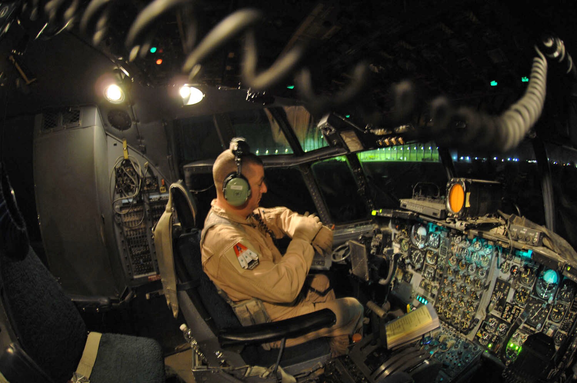 Master Sgt. Louis Carter conducts preflight tests inside the cockpit of an Iraqi C-130E Feb. 2 at Sather Air Base, Iraq. The C-130 was one of two aircraft on its way to pick up Iraqi election ballot boxes. Sergeant Carter is deployed from the 550th Special Operations Squadron at Kirtland Air Force Base, N.M. Sergeant Carter is a 321st Air Expeditionary Airlift Squadron combat aviation adviser. (U.S. Air Force photo/Staff Sgt. Tim Beckham) 
