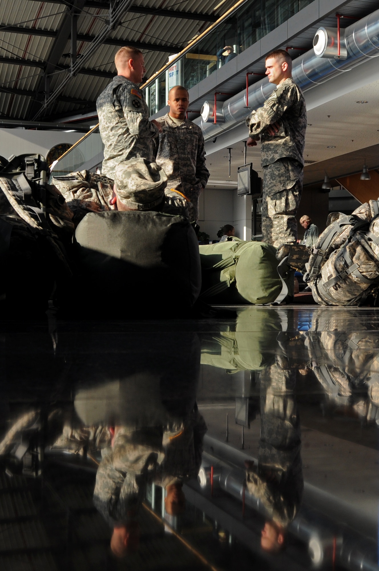 Army troops wait in the passenger area of the Ramstein Air Base Passenger Terminal before departing to the Area of Operation Jan. 26, 2009. The Ramstein PAX terminal, operated by the 721st Aerial Port Squadron, is the only one of its kind in Europe and is the pit stop point for most troops headed downrange.  (U.S. Air Force photo by Airman 1st Class Kenny Holston) 