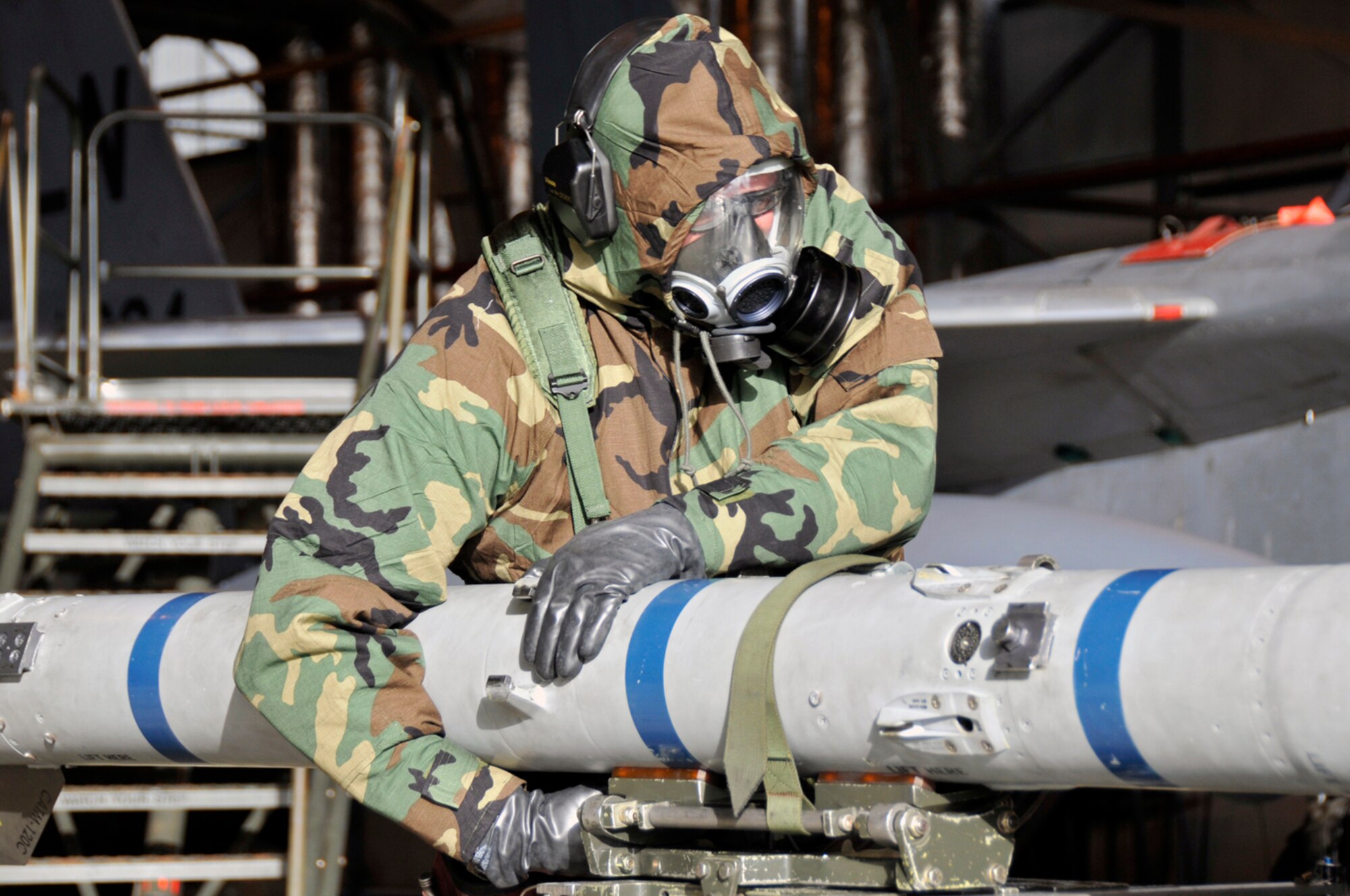 Tech. Sgt. Robert Rutland, 48th Aircraft Maintenance Squadron weapons load crew team leader, rolls an AIM-120 Missile into the proper position for loading Jan. 27 at RAF Lakenheath, England. This weapons load crew was going through load crews certification training. (U.S. Air Force photo by Airman 1st Class Perry Aston)