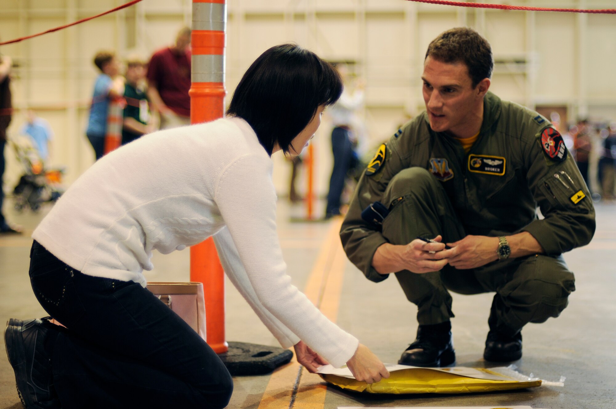 Captain Leo Lemelson, an F-22 pilot with the 27th Fighter Squadron, signs an autograph during an event called 'Meet the Raptor' at Kadena Air Base, Japan Jan. 30, 2009. The event gave all personnel attached to Kadena the opportunity to see the F-22 up close and ask the pilots questions. The F-22s are deployed here from Langley Air Force Base, Virginia in support of U.S. Pacific Command. (U.S. Air Force photo/Airman 1st Class Chad Warren)