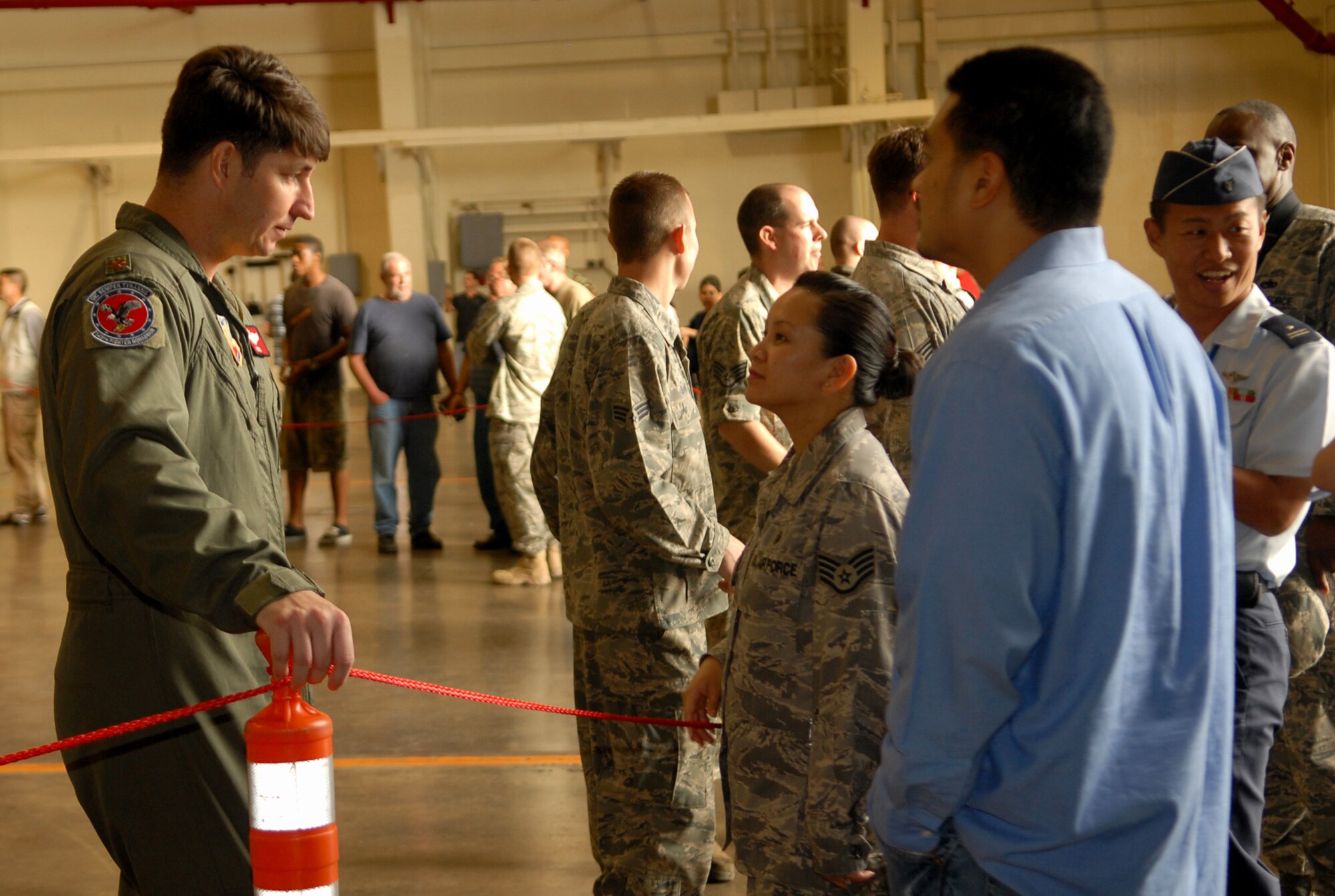 Maj. Steve Bunting, an F-22 pilot from the 149th Fighter Squadron, talks to visitors on Kadena Air Base, Japan. Meet the Raptor Day was hosted by the 18th Wing and the 27th Expeditionary Fighter Squadron at the Kadena Air Base Jan. 30.  (US Air Force photo/Junko Kinjo)