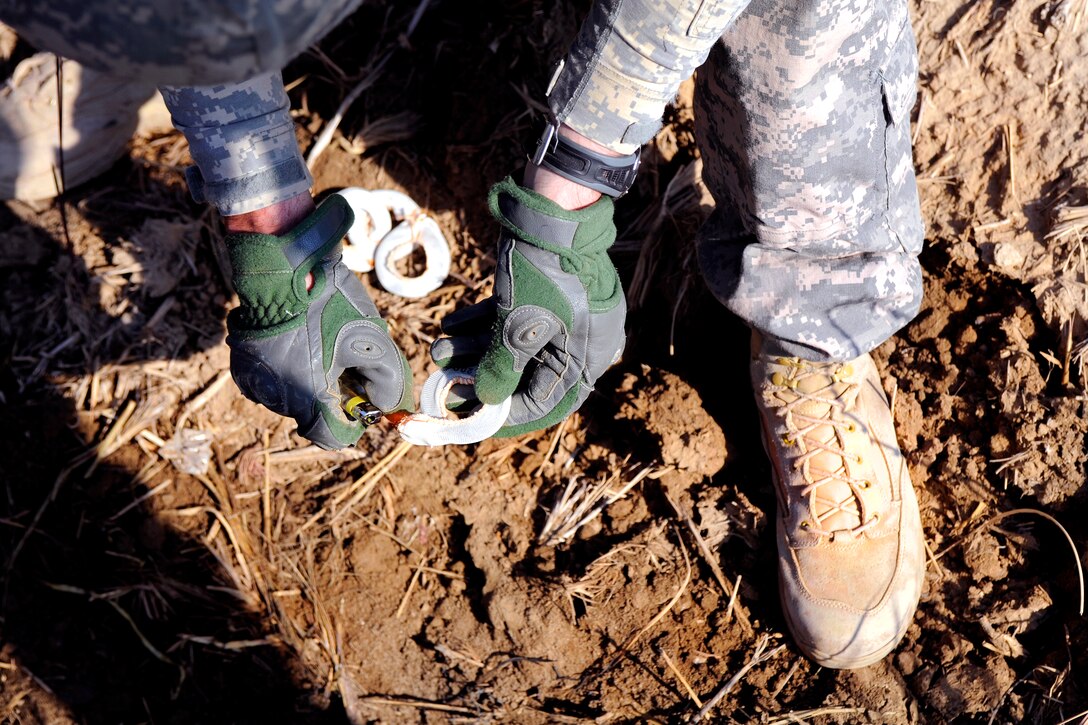 U.S. Army Staff Sgt. Matthew Arnold lights a propellant pack to demonstrate the highly flammable material inside, in the Doura district, Baghdad, Jan. 22, 2009.