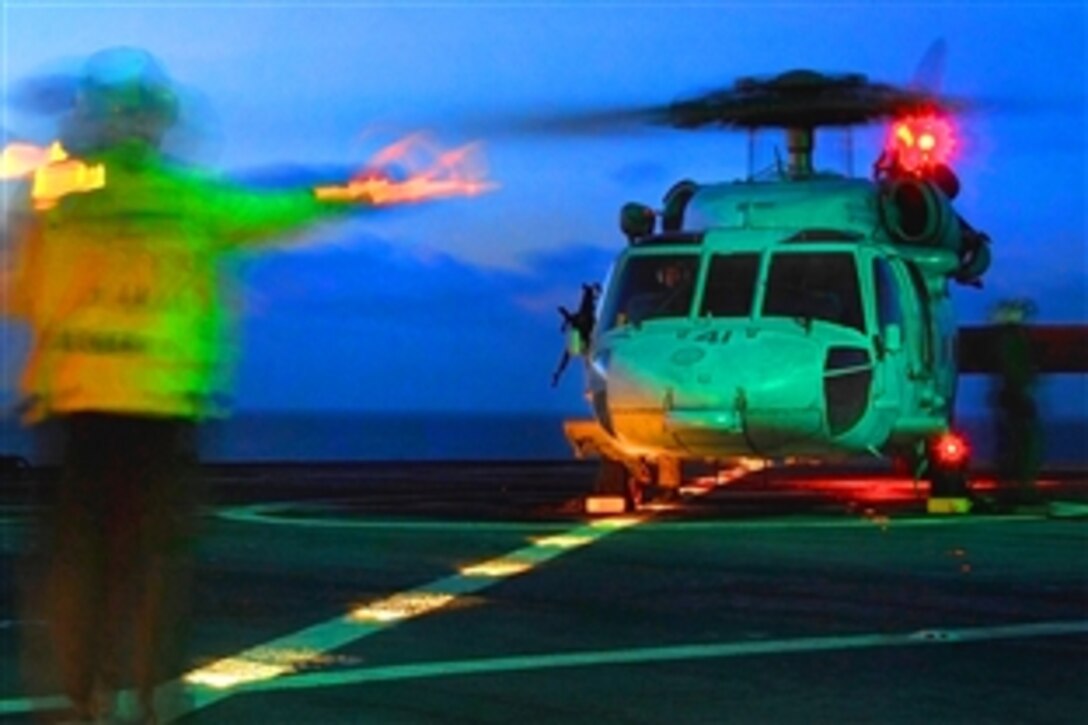An MH-60 Sea Hawk helicopter lands aboard the amphibious command ship USS Mount Whitney after conducting in-flight gun qualifications in the Mediterranean Sea, Jan. 31, 2009. The USS Mount Whitney is supporting Austere Challenge 2009, which is designed to exercise U.S. capability across the full range of military operations in the European theater.