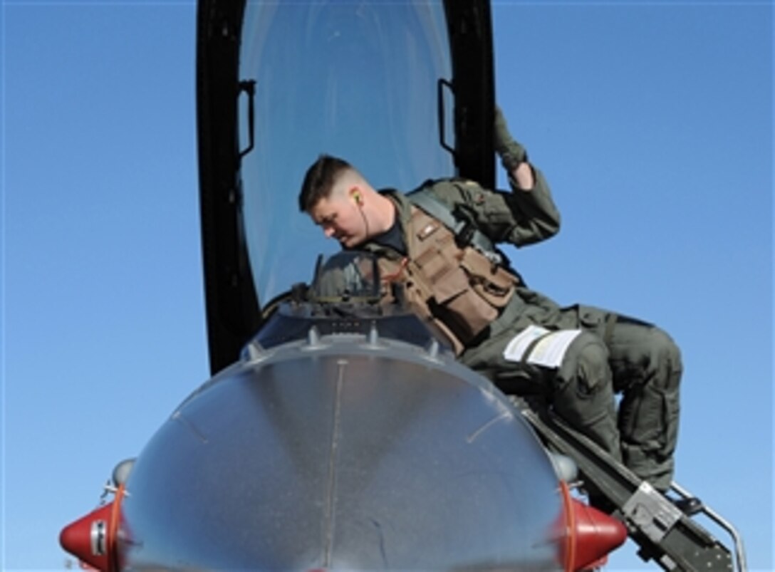 U.S. Air Force Capt. Joseph White of the 22nd Fighter Squadron, Spangdahlem Air Base, Germany, makes final preparations for a flight in an F-16CJ Fighting Falcon at the U.S. Air Force Weapons School, Nellis Air Force Base, Nev., on Jan. 29, 2009.  The Weapons School is responsible for teaching graduate-level instructor courses that provide advanced training in weapons and tactics.  
