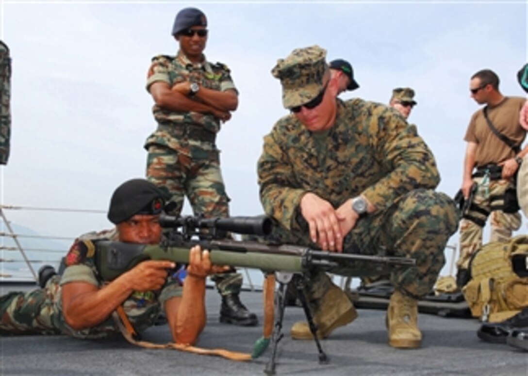 U.S. Marine Corps Gunnery Sgt. Alex Carlson explains functions and specifications as a Timor-Leste Defense Force sailor tries out an M-14 rifle aboard the guided-missile destroyer USS Lassen (DDG 82) while in port in Dili, Timor-Leste, on Jan. 28, 2009.  The Lassen, assigned to Destroyer Squadron 15 and forward deployed to Yokosuka, Japan, is in Dili for a port visit and is engaging in goodwill activities.  