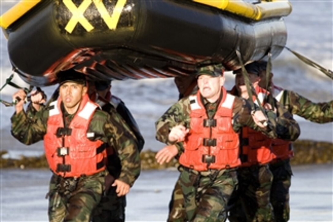 U.S. Navy Basic Underwater Demolition/SEAL students race down the beach during their first Surf Passage evolution at the Naval Special Warfare Center at Naval Amphibious Base Coronado, Calif., on Jan. 27, 2009.  