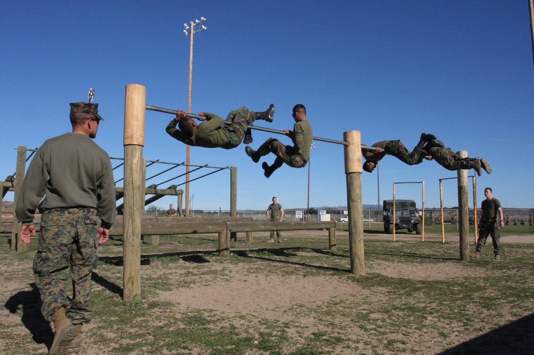 Sgt. Carlos J. Hernandez, the platoon sergeant of 2nd Platoon, Company G, 2nd Battalion, 7th Marine Regiment, watches as members of the Singaporean Armed Forces maneuver through the obstacle course at Marine Corps Base Camp Pendleton, Calif., Feb. 4.