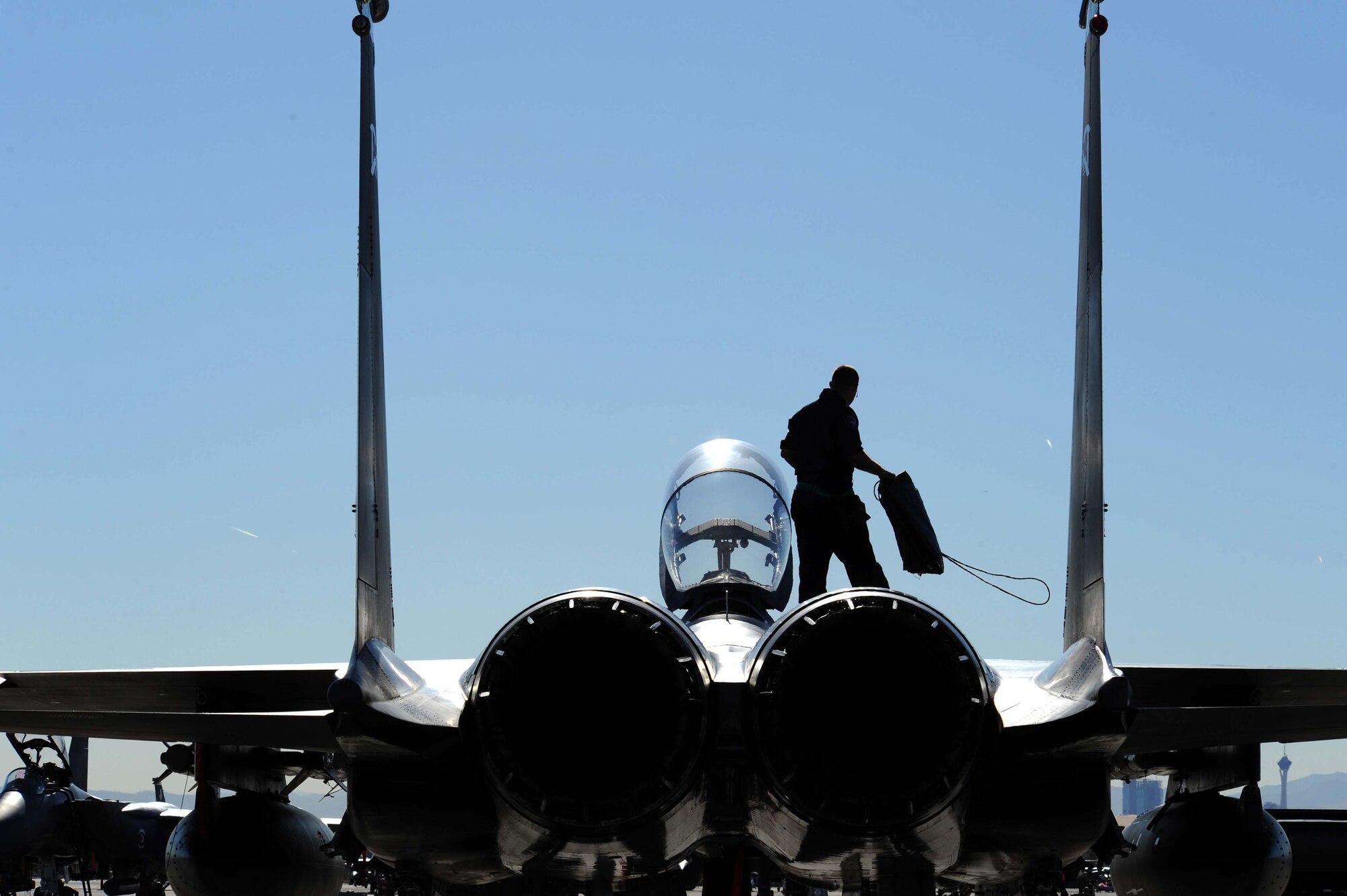 Airman 1st Class Joey Cherry, an F-15E Strike Eagle crew chief assigned to the 4th Aircraft Maintenance Unit, Seymour Johnson Air Force Base, N.C., prepare to put intake covers on his jet after a training mission during Red Flag 09-2 at Nellis AFB, Nev., Jan. 30. Red Flag is a multi-national exercise providing a realistic environment to practice combat scenarios. The experience gained during the exercise is vital to the survival of air crews in combat.
(U.S. Air Force photo/Senior Airman Larry E. Reid Jr.)