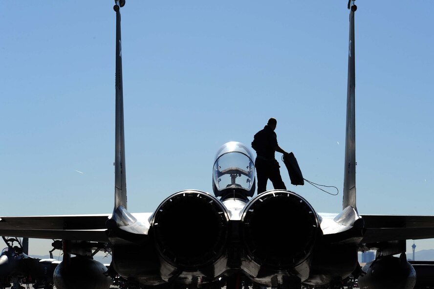 Airman 1st Class Joey Cherry, an F-15E Strike Eagle crew chief assigned to the 4th Aircraft Maintenance Unit, Seymour Johnson Air Force Base, N.C., prepare to put intake covers on his jet after a training mission during Red Flag 09-2 at Nellis AFB, Nev., Jan. 30. Red Flag is a multi-national exercise providing a realistic environment to practice combat scenarios. The experience gained during the exercise is vital to the survival of air crews in combat.(U.S. Air Force photo/Senior Airman Larry E. Reid Jr.)