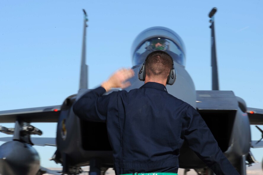 Senior Airman James Steffes, an F-15E Strike Eagle crew chief assigned to the 4th Aircraft Maintenance Unit, Seymour Johnson Air Force Base, N.C., taxis in his jet during Red Flag 09-2 at Nellis AFB, Nev., Jan. 30. Red Flag is a multi-national exercise providing a realistic environment to practice combat scenarios. The experience gained during the exercise is vital to the survival of air crews in combat. (U.S. Air Force photo/Senior Airman Larry E. Reid Jr.)
